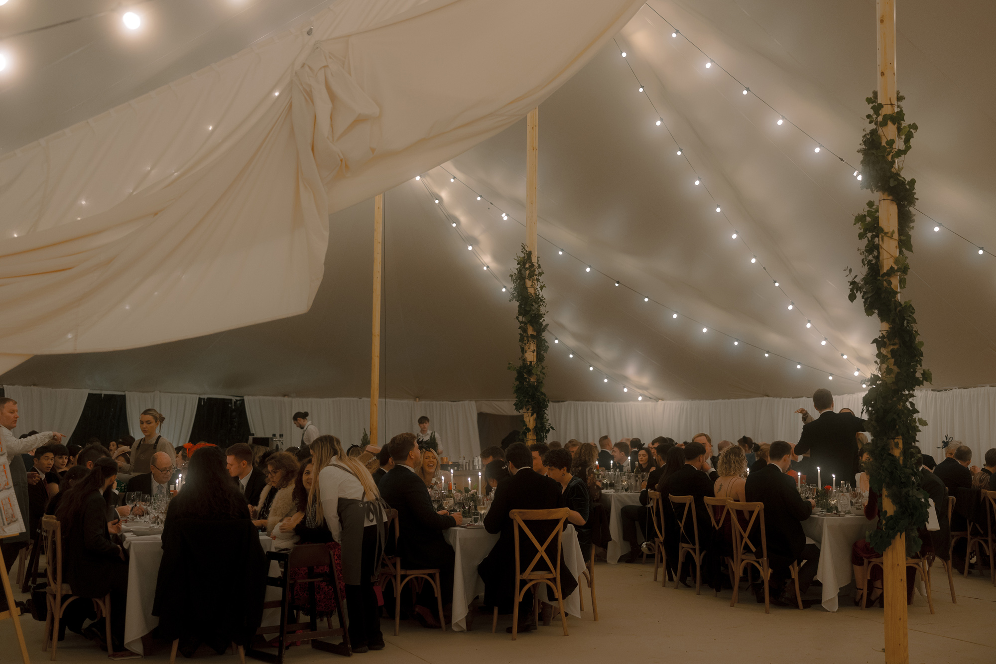 A Movie & Literary Inspired Romantic Christmas Wedding 62 Wedding marquee decorated with festoon lights.