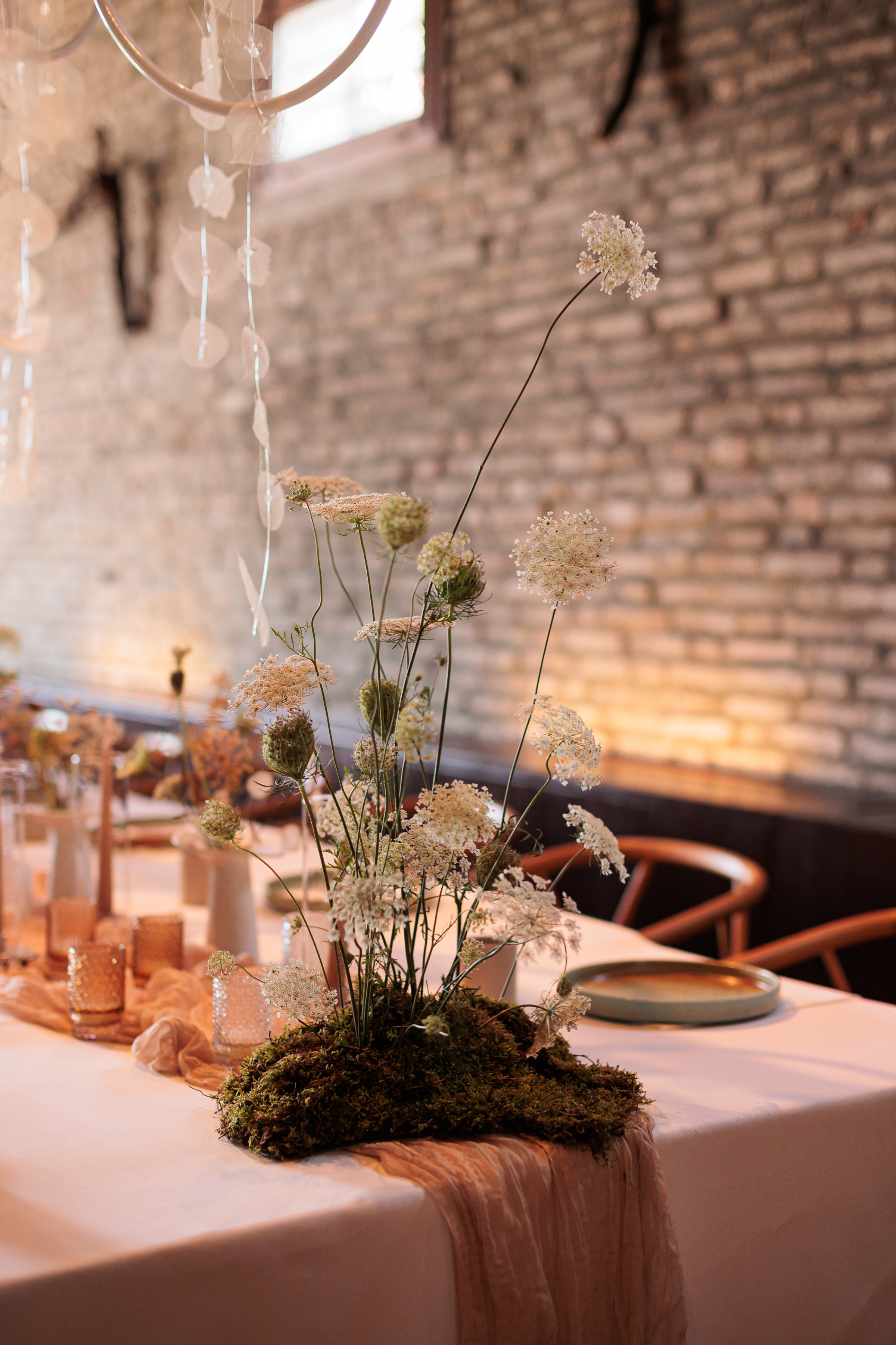 Danielle Frankel Intimate Italian Wedding 34 - Kathryn in Danielle Frankel for her Intimate Italian Wedding Wedding table flowers on beds of moss.