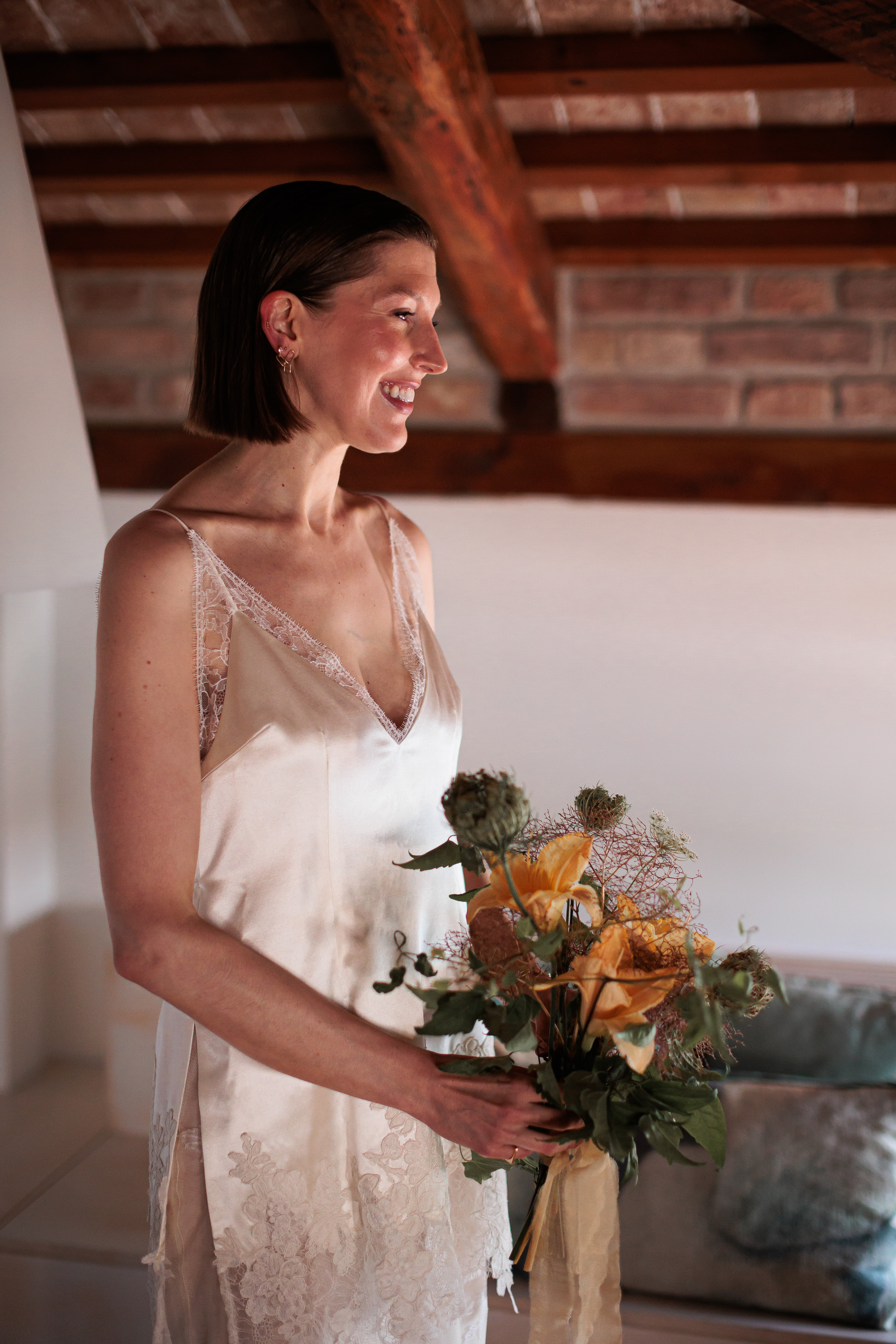 Danielle Frankel Intimate Italian Wedding 62 - Kathryn in Danielle Frankel for her Intimate Italian Wedding Bride wearing Danielle Frankel and carrying a summer wedding bouquet of dried flower heads and lilys.