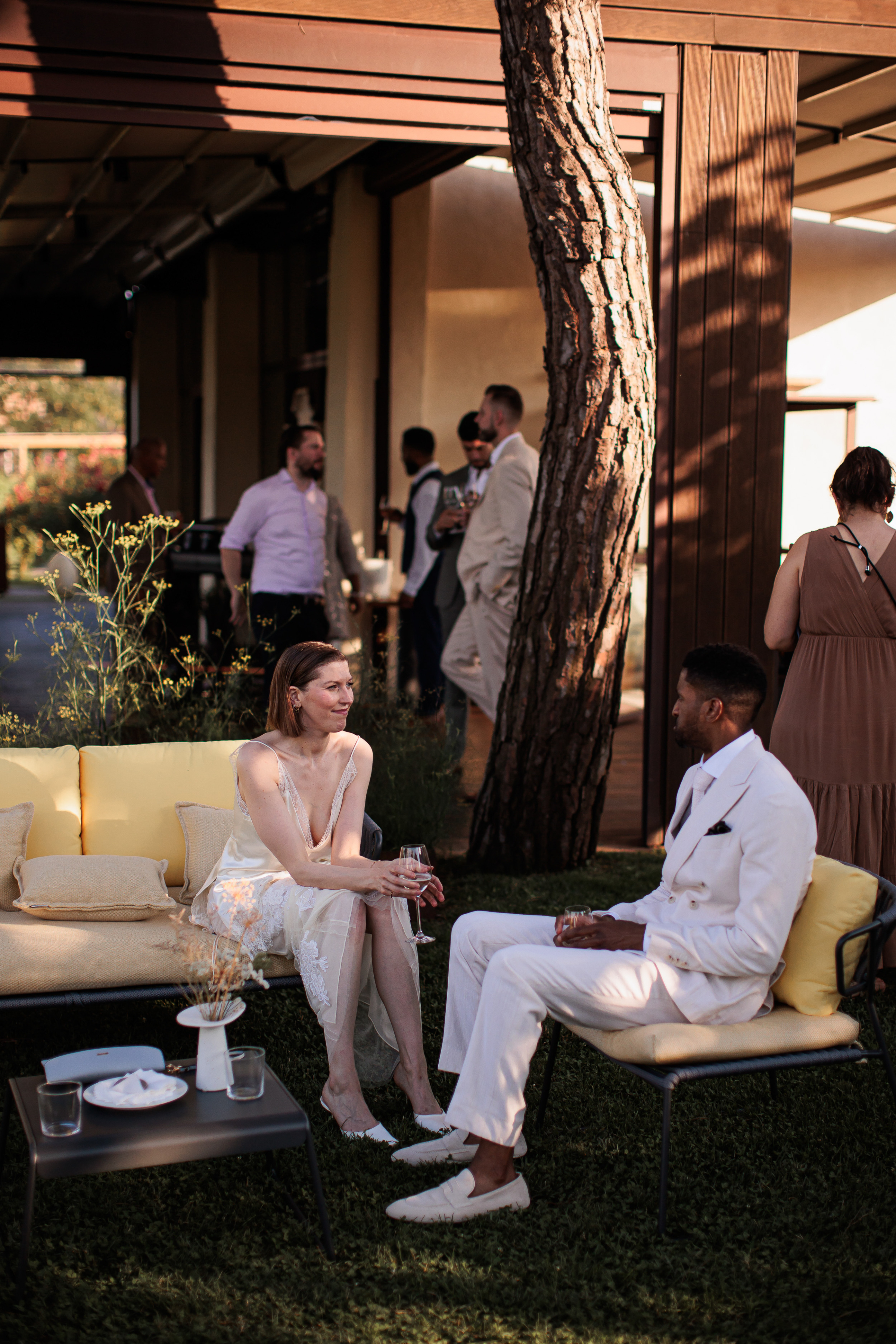 Danielle Frankel Intimate Italian Wedding 88 - Kathryn in Danielle Frankel for her Intimate Italian Wedding Modern bride and groom seated on modern chairs at their wedding ceremony. She wears Danielle Frankel and mules by Manolo Blahnik.