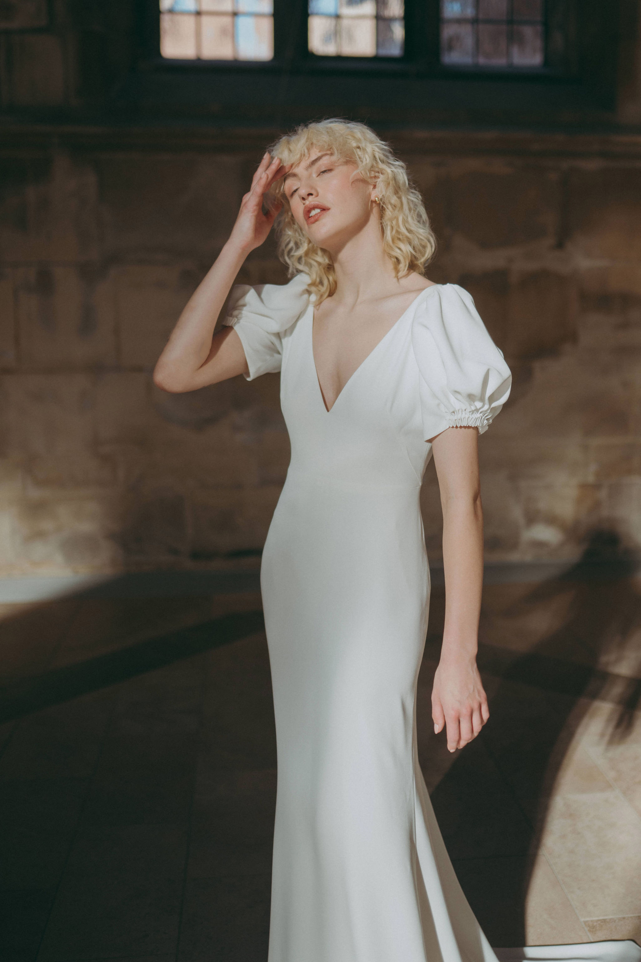 Modern wedding dress with gentle puff sleeves, by Rolling in Roses. Ethical and Sustainable modern British bridal fashion.
