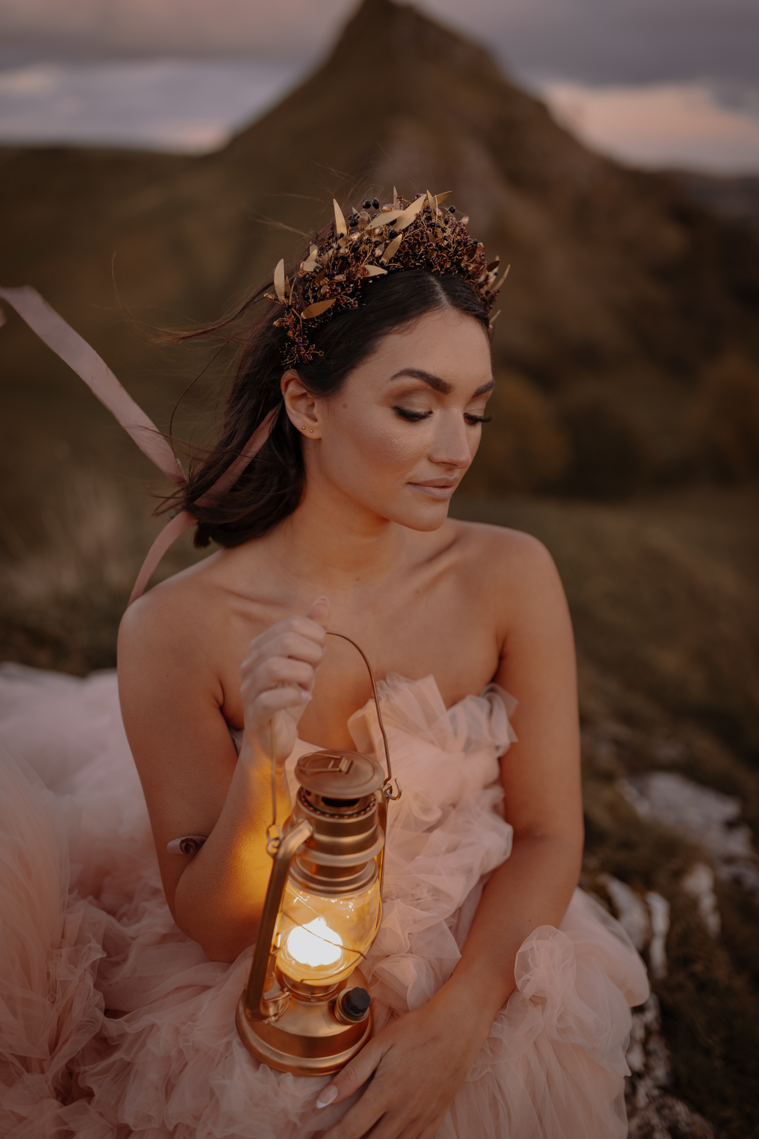 A Little Wild, A Little Luxe: Helen Rose Photography's Beautiful Peak District Editorial 30 Brid with a pink ruffled dress on carrying a lantern and wearing a crown.