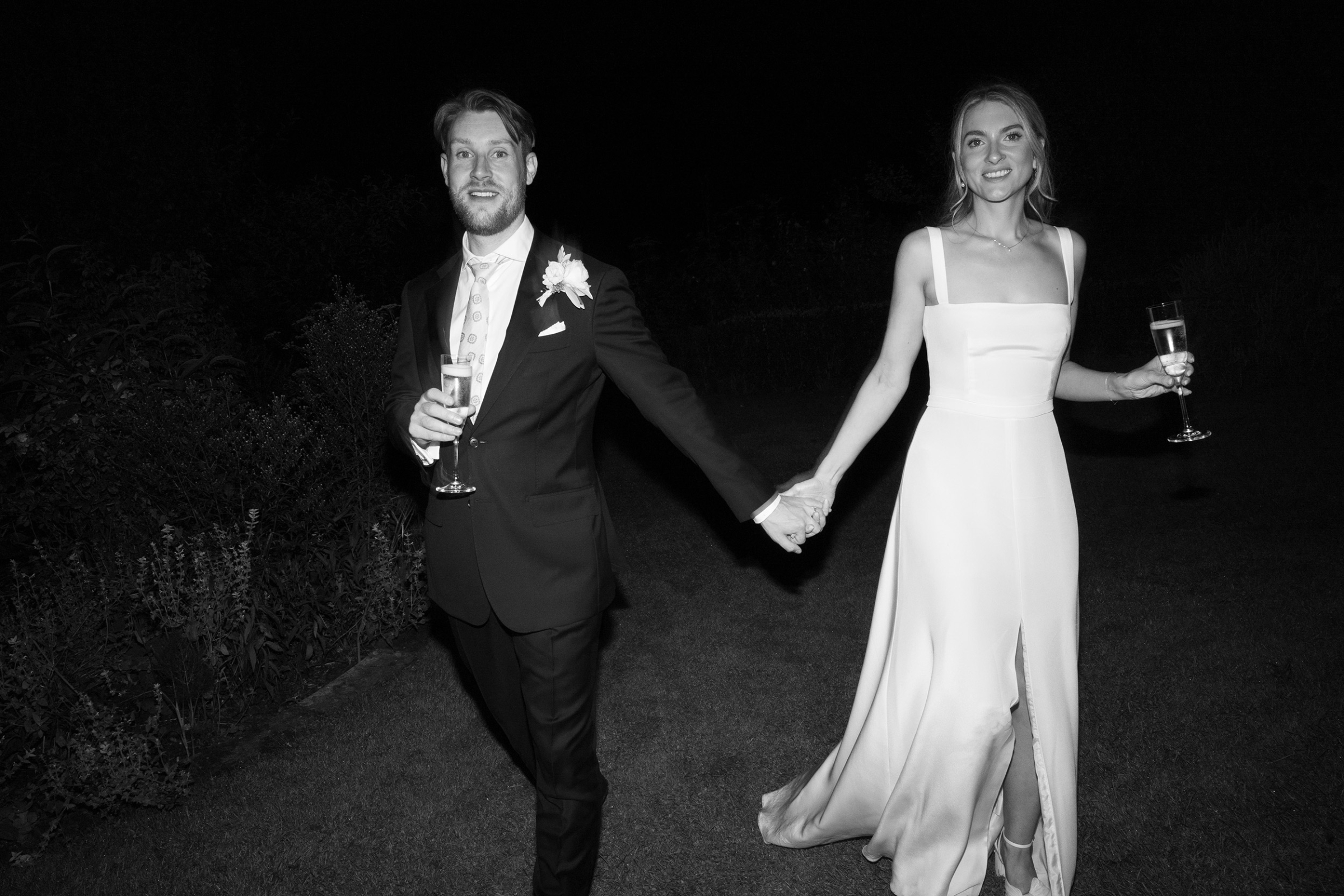 Sophie’s Clover London Wedding at Pythouse Kitchen Garden, Wiltshire 49 Cool black and white photograph of bride and groom captured at night. The bride wears Clover London.