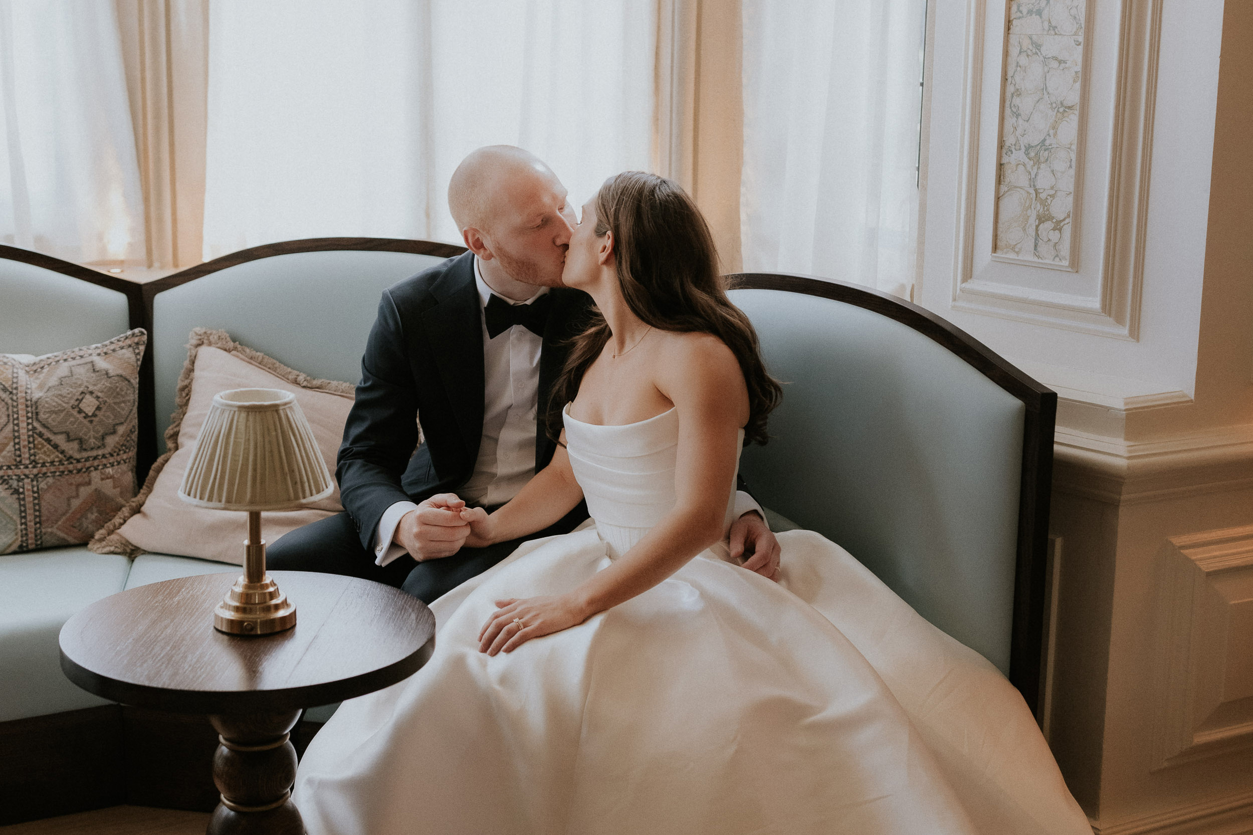 Groom leaning forward to kiss his bride. Kin House wedding in Wiltshire.