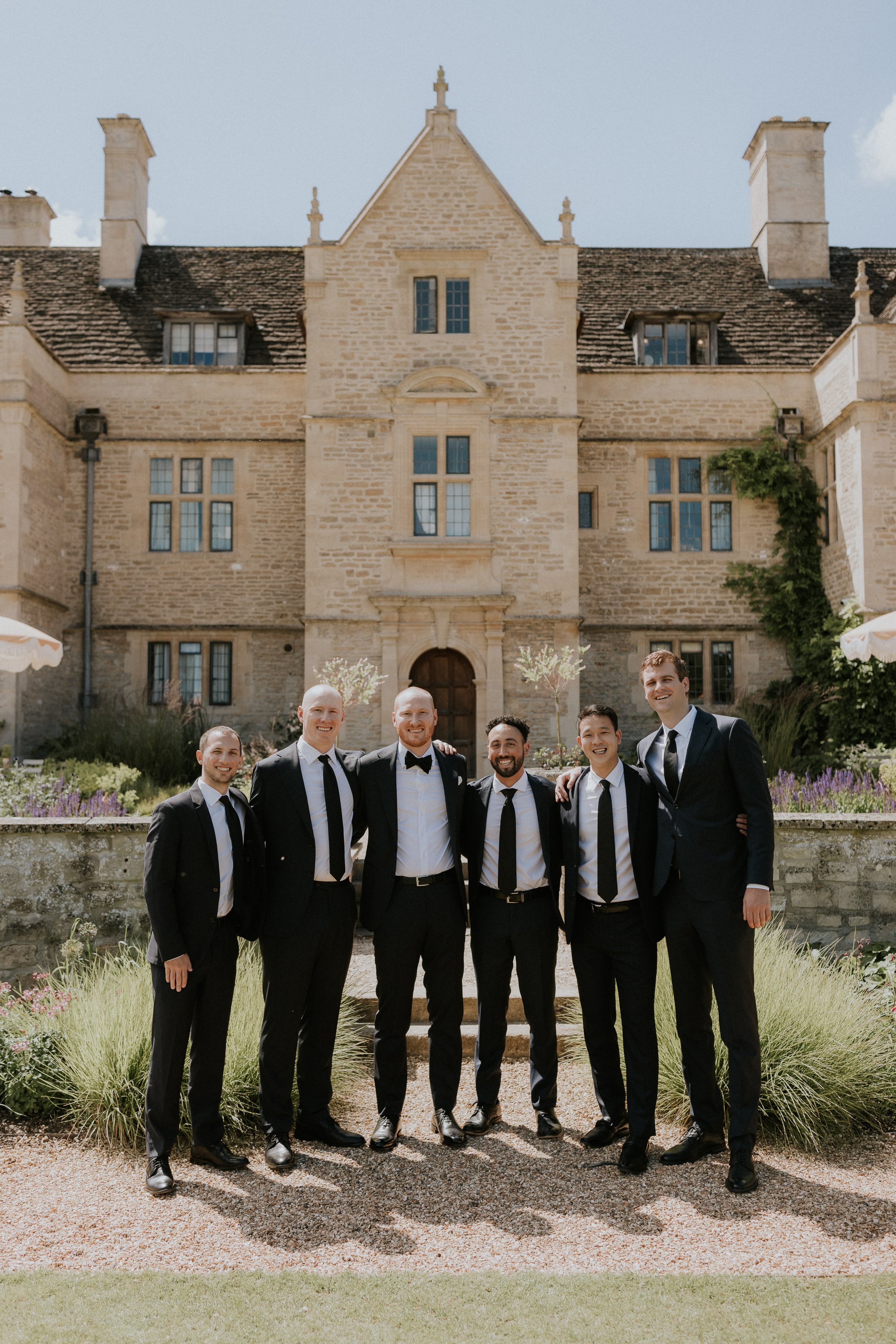 A Romantic Summer Wedding at Kin House in Wiltshire 25 Groom and his groomsmen in black tie at Kin House in Wiltshire. Maja Tsolo Photography.