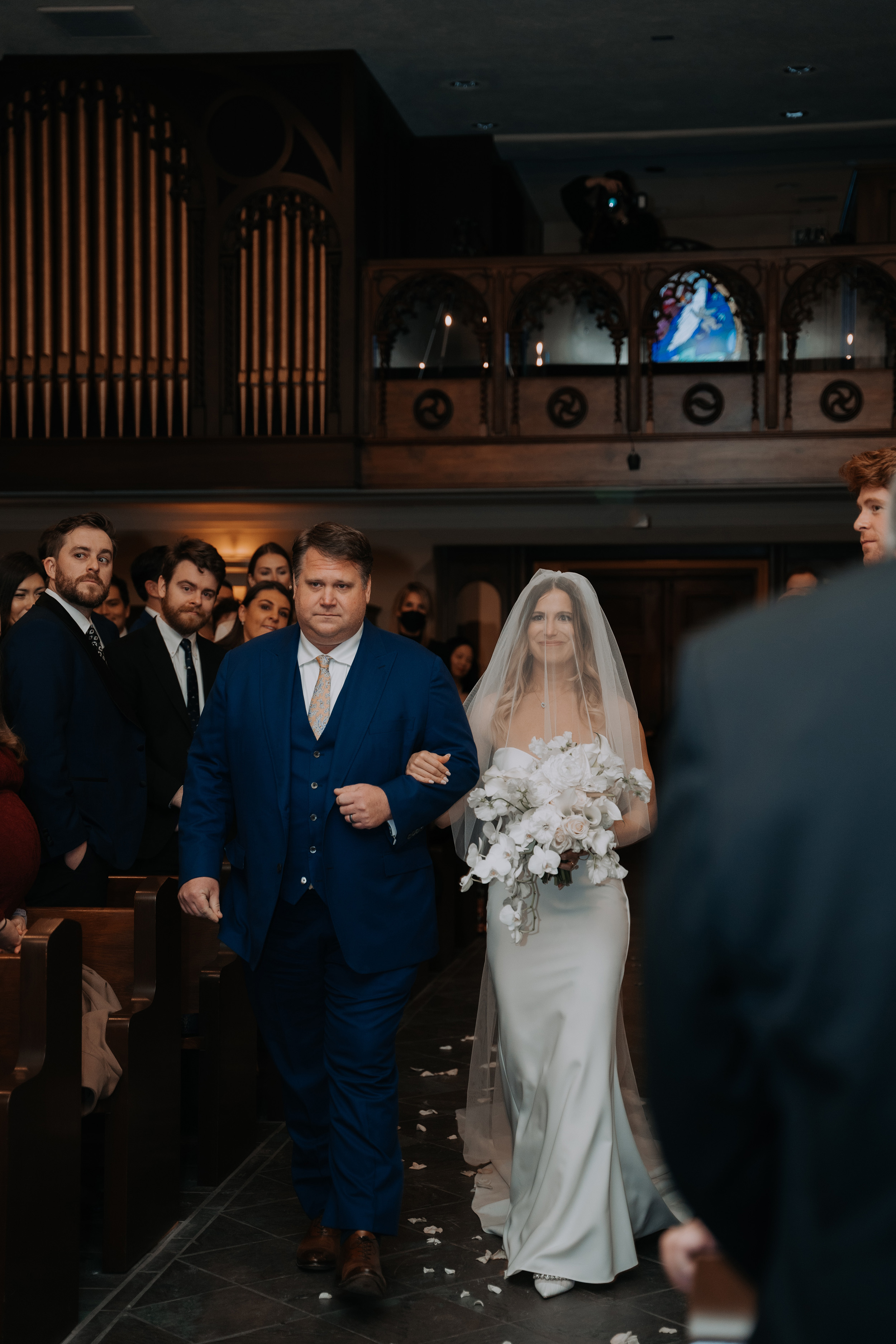 Bride being accompanied by her father down the aisle. Made With Love Bridal wedding dress.