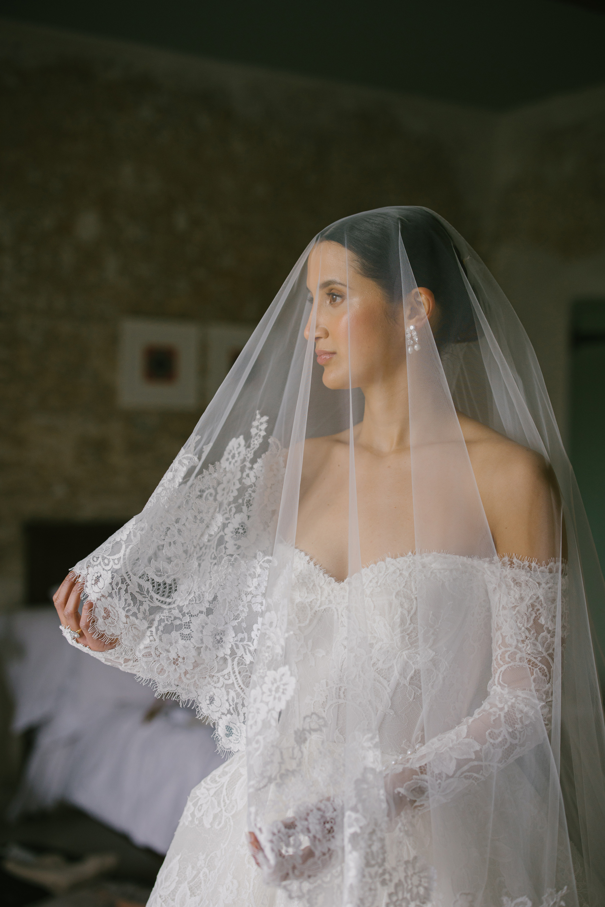A Josephine Scott Bride & her Romantic Spring Wedding in Somerset 16 Elegant portrait of a modern bride wearing an off the shoulder lace wedding dress by Josephine Scott. She wears a single tier lace trimmed veil over her face.