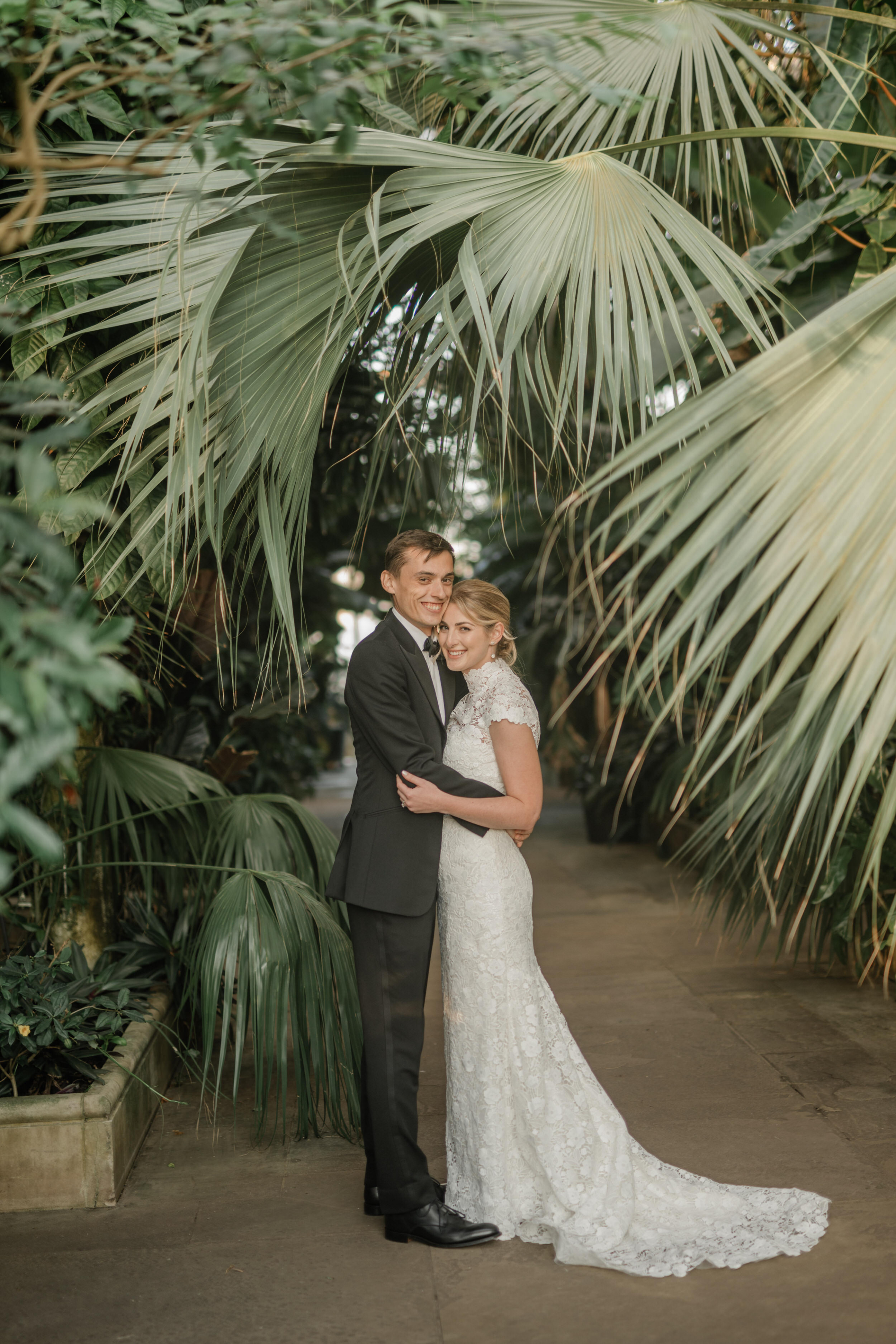 Kew Gardens wedding - the couple are standing in amidst giant plants