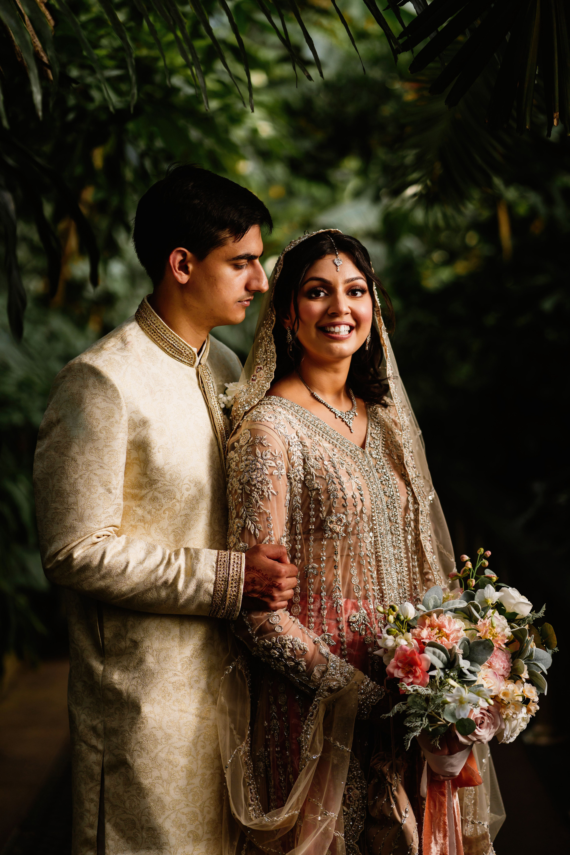 A Romantic Muslim Wedding at Kew Gardens with South Asian Elegance 27 South Asian bride in pink dress, Groom in a pale gold Sherwani. Muslim wedding at Kew Gardens London