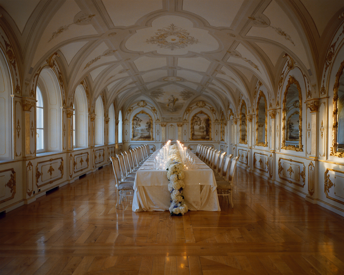 An Elegant Destination Wedding in Cortona, Italy, with a Peter Langner Gown 39 Wedding reception setup at Relais La Corte Dei Papi in Cortona with cream and blue hydrangea rolling off the table.