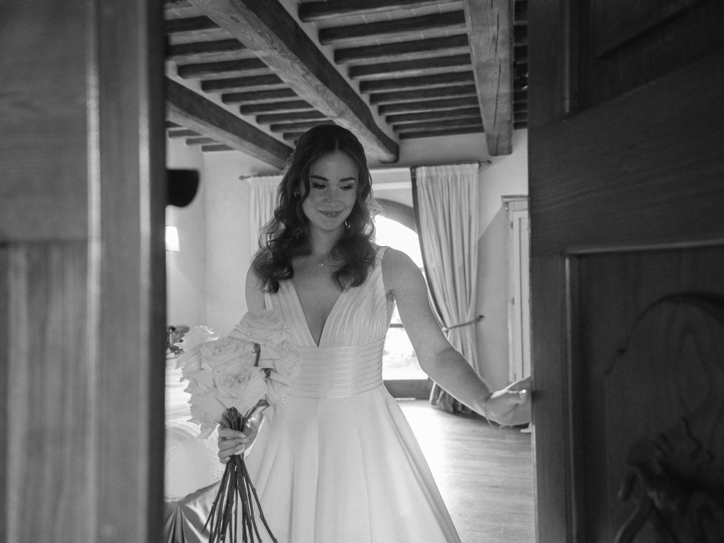 An Elegant Destination Wedding in Cortona, Italy, with a Peter Langner Gown 22 Bride wearing a Peter Langner wedding dress and carrying a bouquet of white flexed roses.