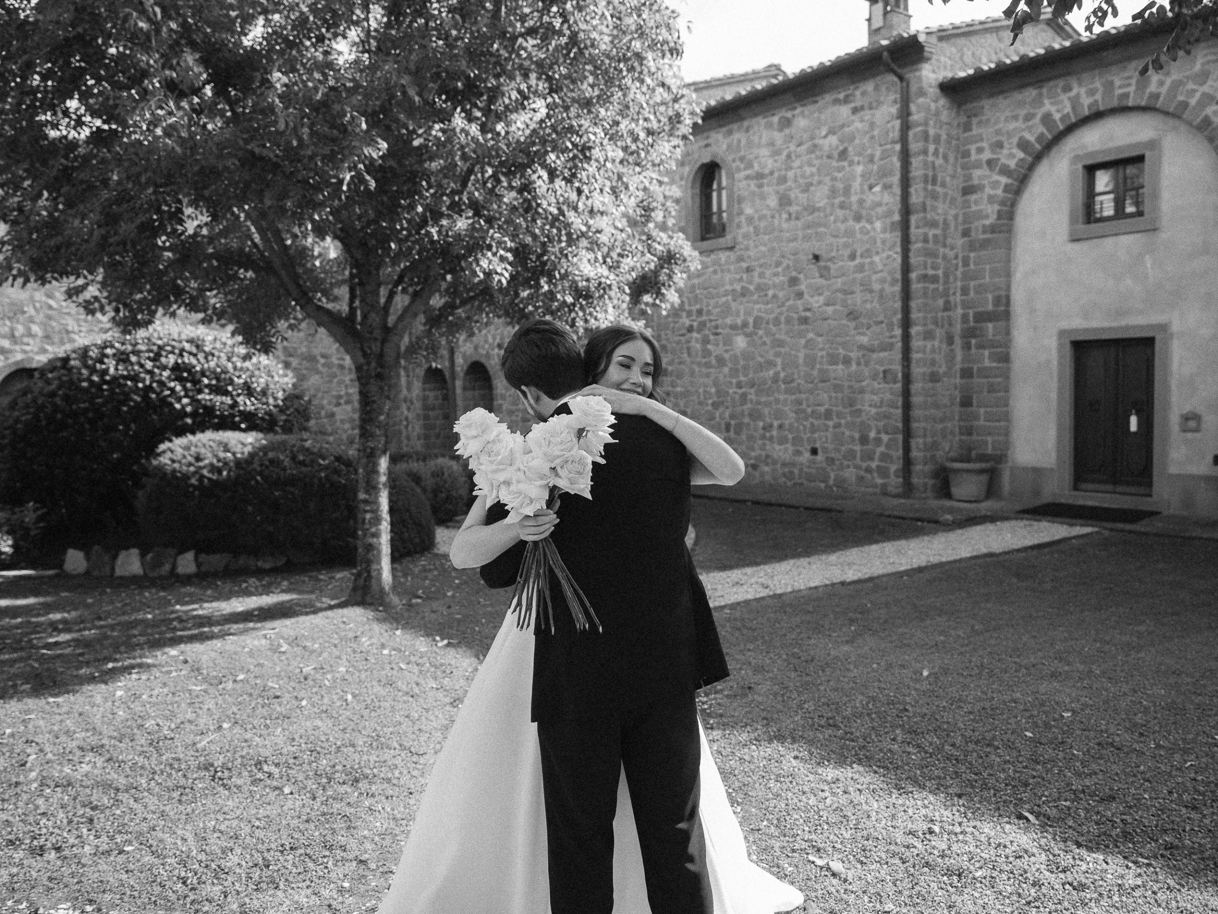 An Elegant Destination Wedding in Cortona, Italy, with a Peter Langner Gown 26 Bride and groom embrace during their first look during an Italian wedding.