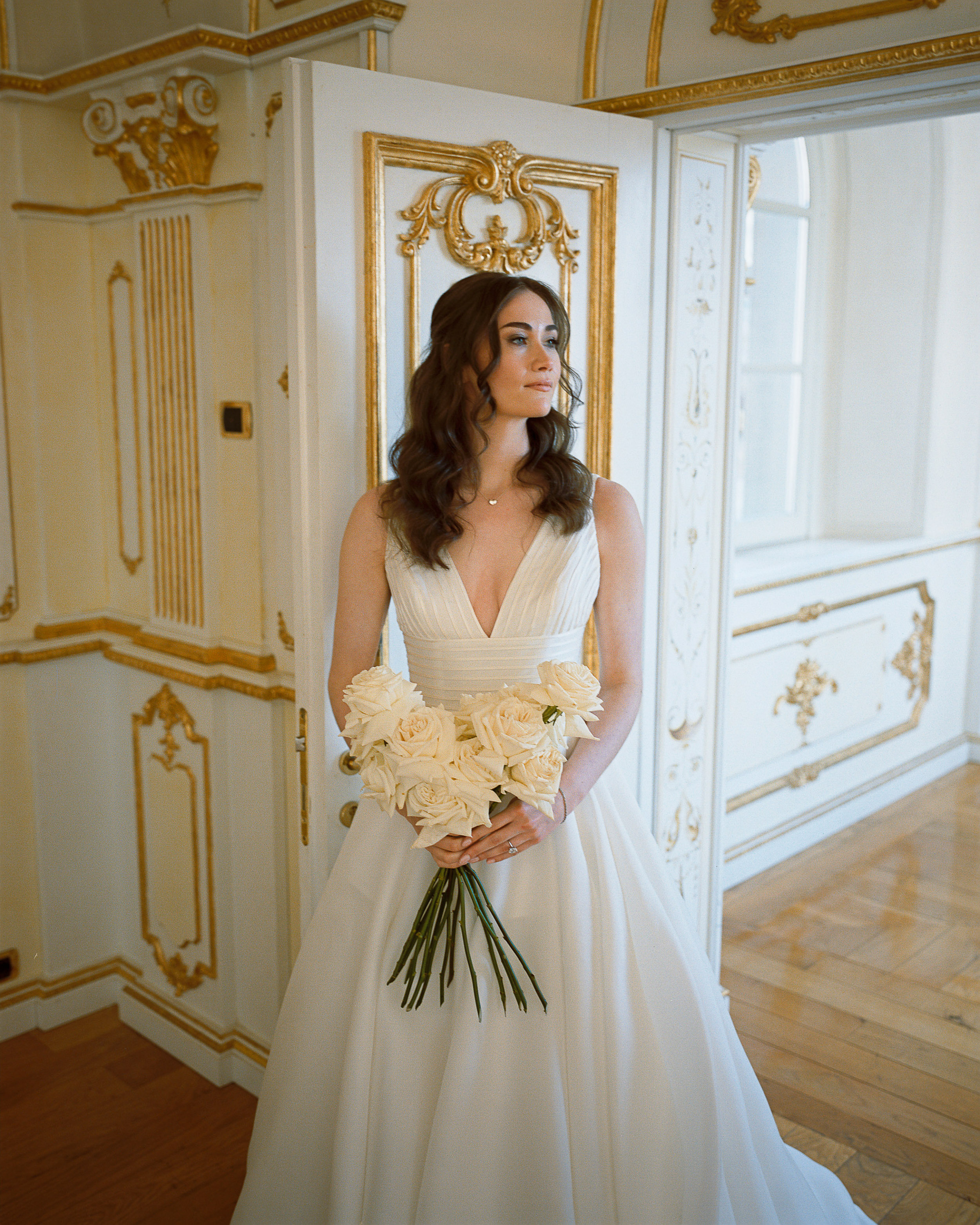 An Elegant Destination Wedding in Cortona, Italy, with a Peter Langner Gown 23 Bride wearing a Peter Langner wedding dress and carrying a bouquet of white flexed roses.