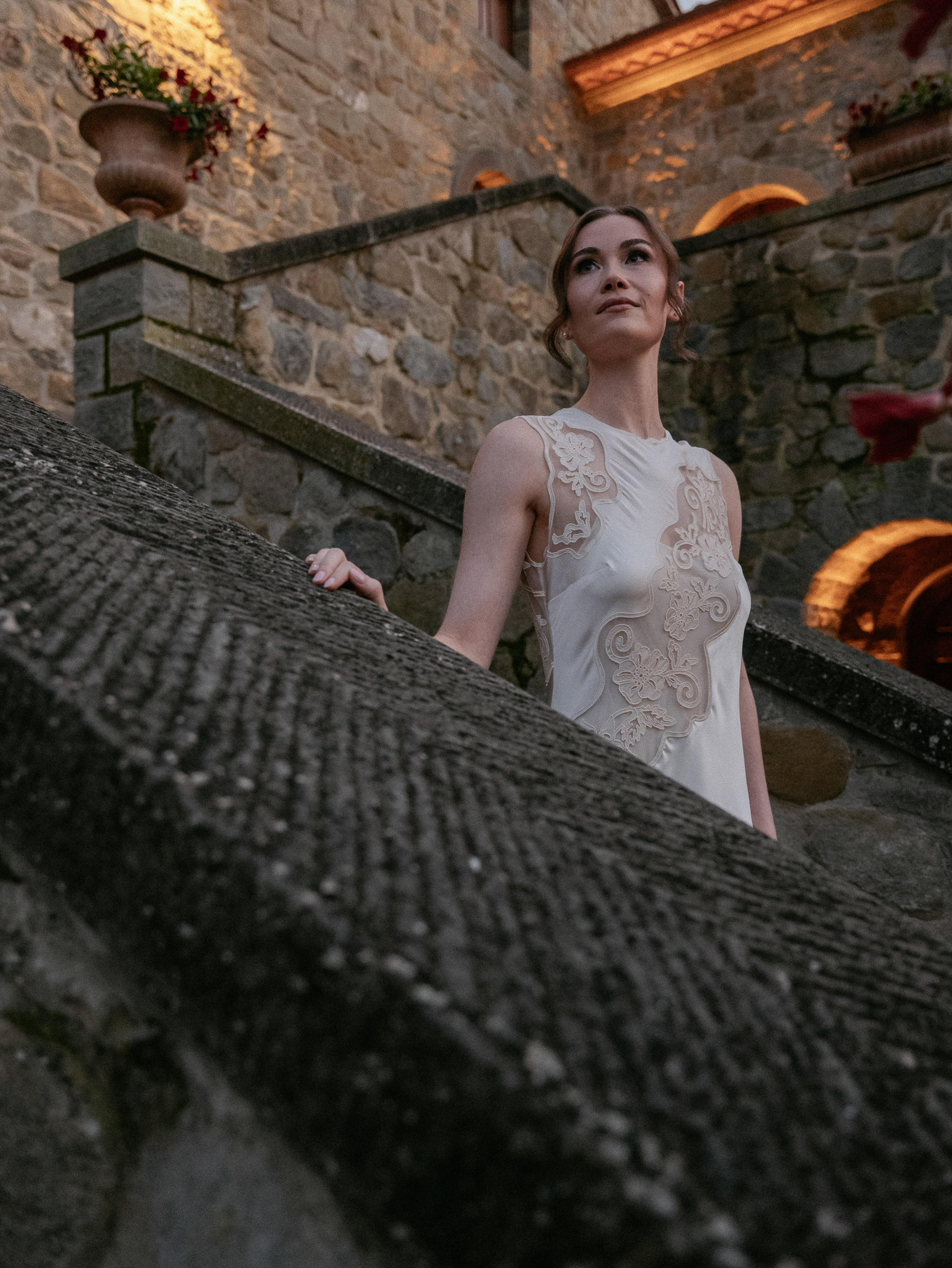 Bride in a lace dress for her rehearsal dinner at Relais La Corte Dei Papi wedding venue in Cortana, Italy.