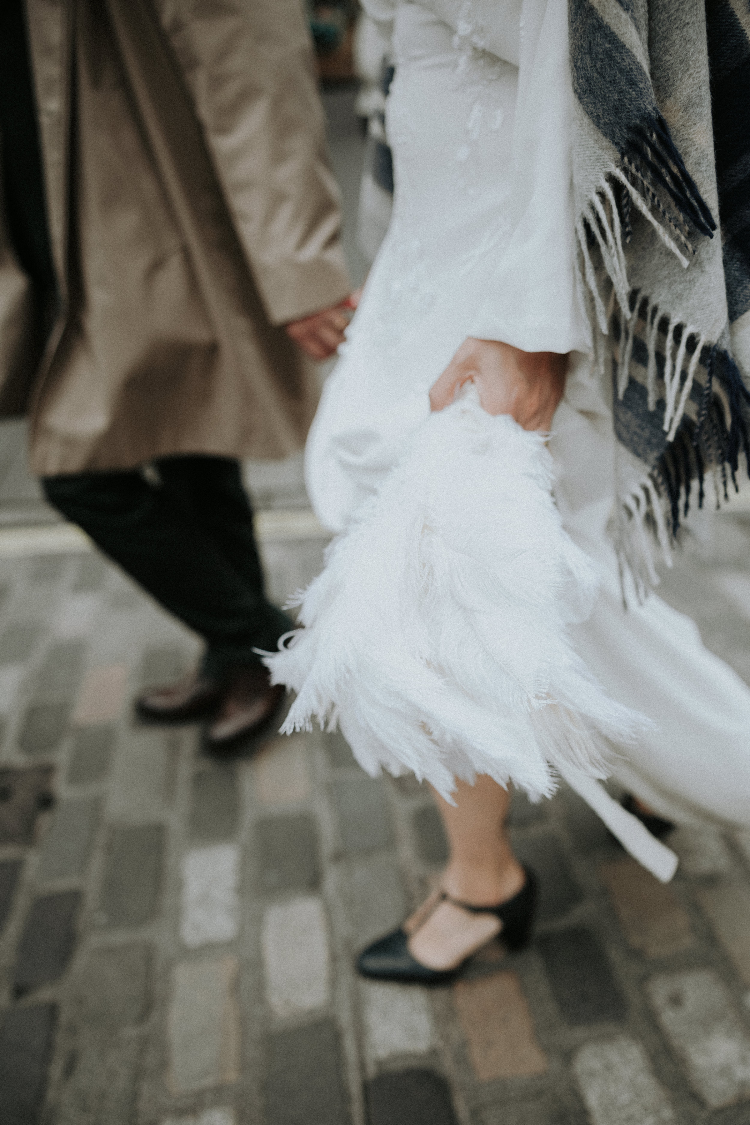 Motion blur shot of bride and groom walking through the streets of Edinburgh. Bernadeta Kupiec Photography.
