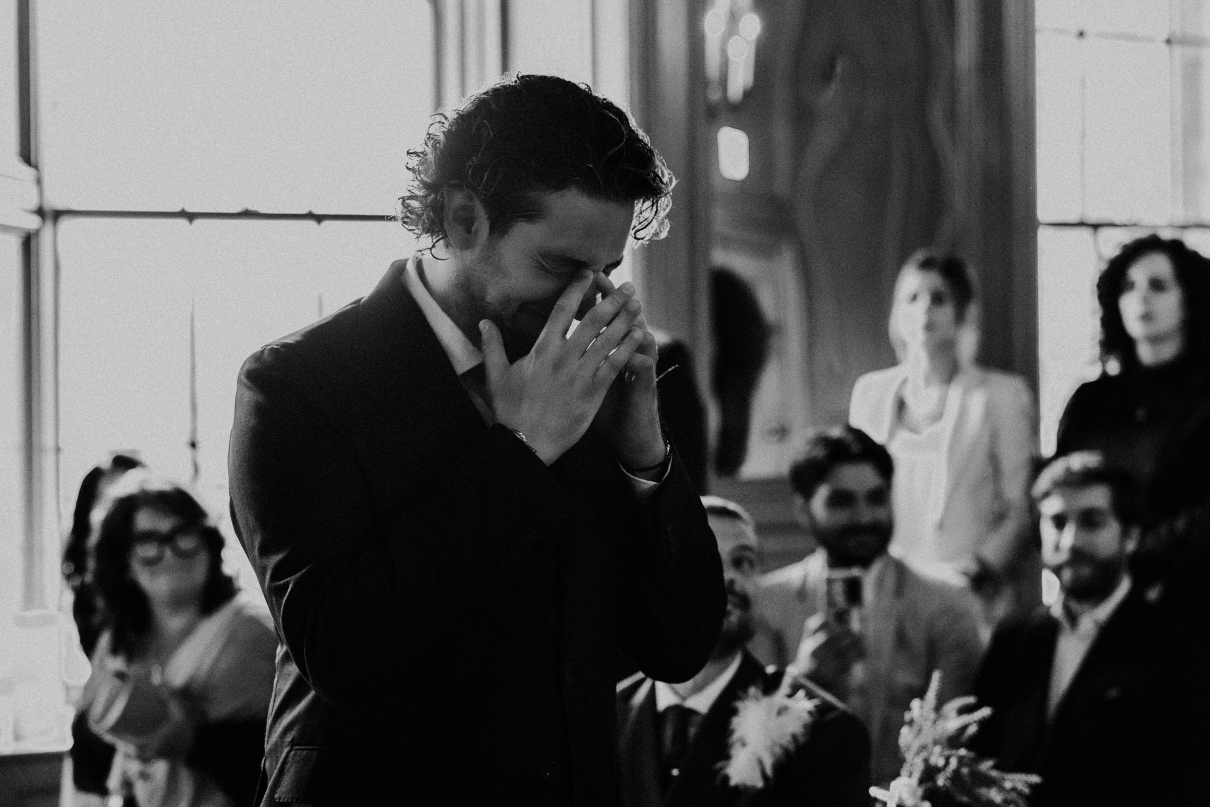 Groom reacting emotionally to seeing his bride walk down the aisle. Bernadeta Kupiec Photography.