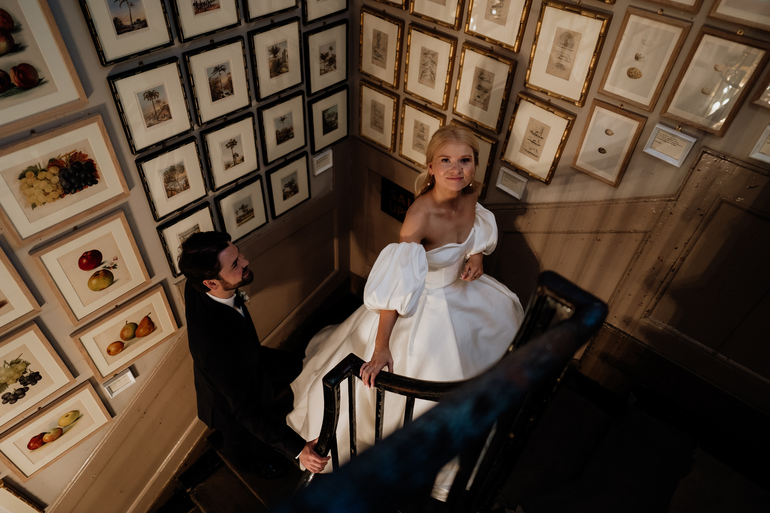 Bride with puff sleeve wedding dress walking up the stairs at Brunton House in London.