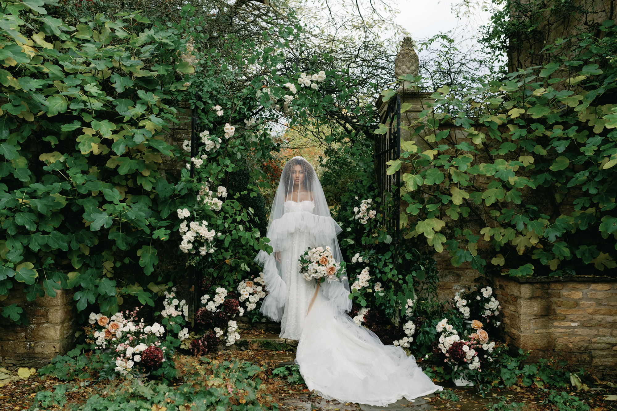 Bride standing outside Cornwell Manor in The Cotswolds.