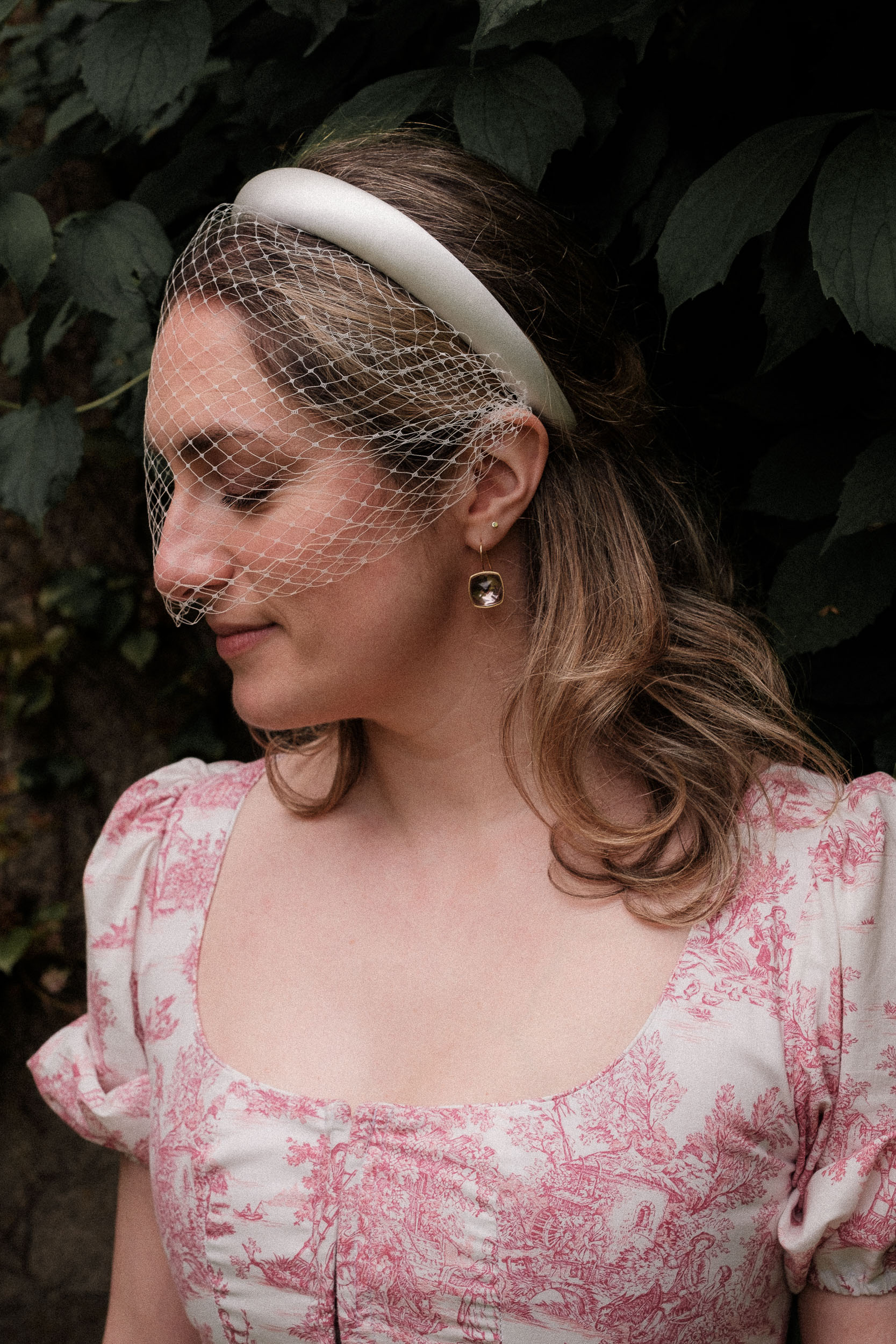 Constance paired her Annina Dirndl two-piece with a satin padded Jennifer Behr headband and birdcage veil – adding just the right touch of bridal elegance. Gold drop earrings completed the look for this stylish spring wedding in France.