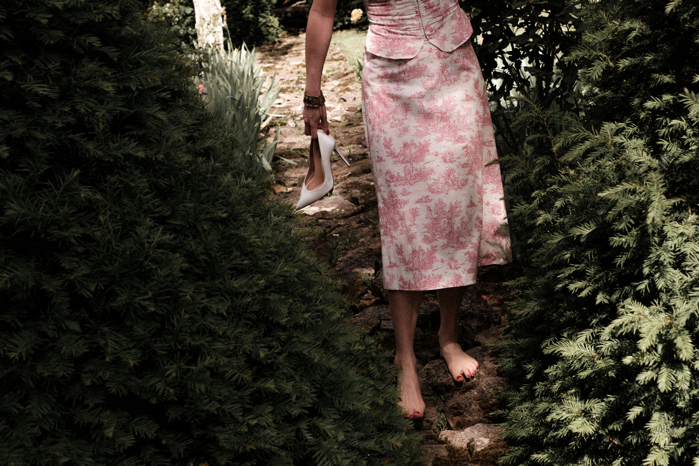A quiet, joyful moment from this intimate village wedding in Manonviller, France. The bride, barefoot in the garden, carrying her white satin heels – a perfect snapshot of the relaxed, personal nature of the day.