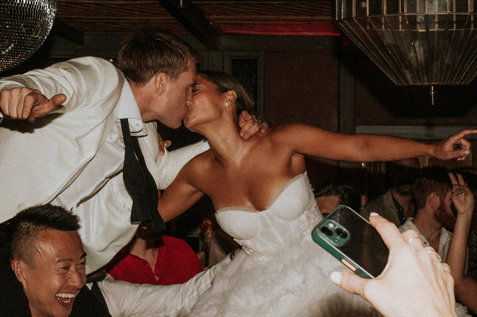 Bride and groom dancing with wild abandon beneath the disco ball at their Marrakech wedding.