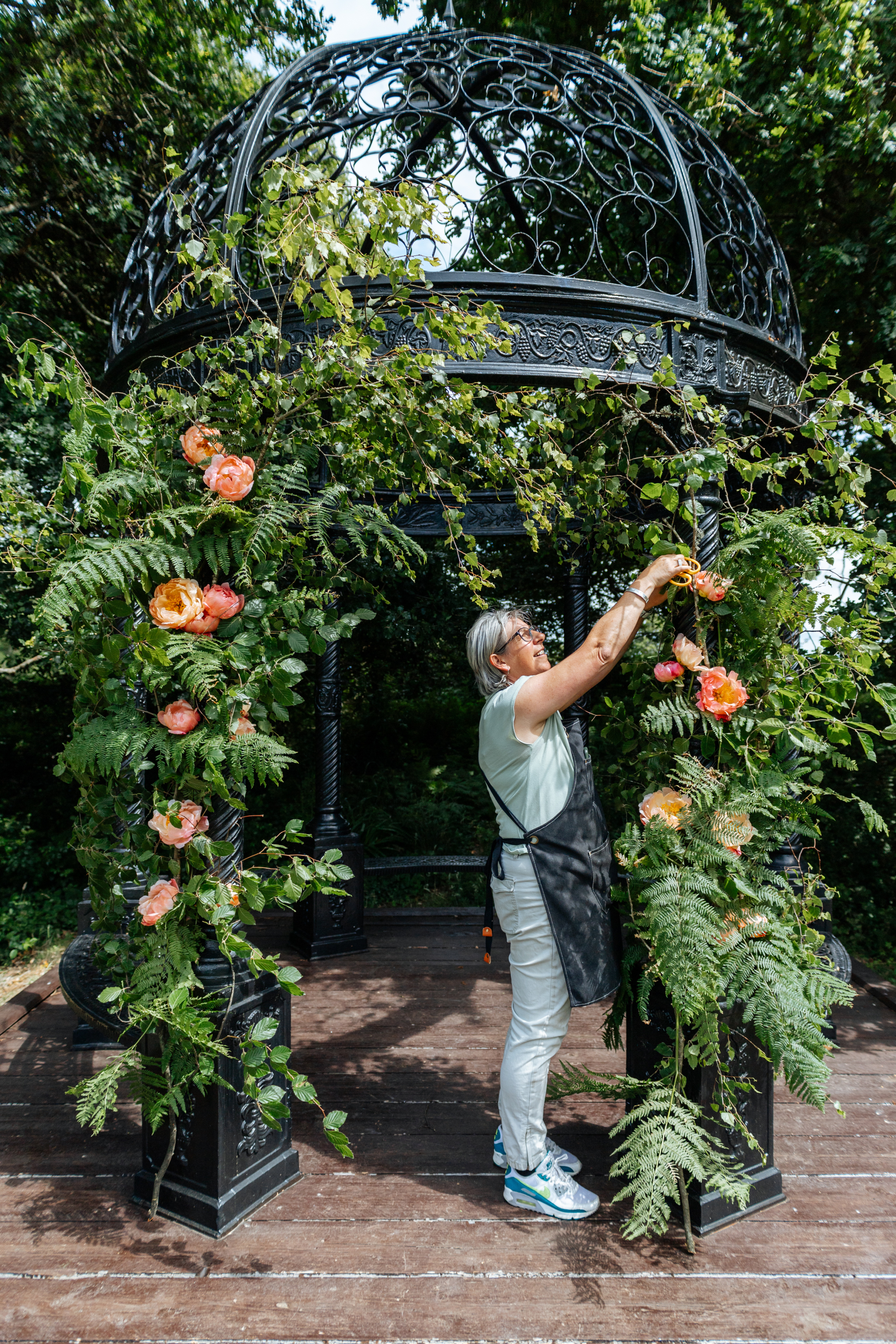 Nia Bradley-Hobbs of Luvshifting Flowes, a Hampshire wedding florist. She is creating a wedding floral arch with fern and peonies.