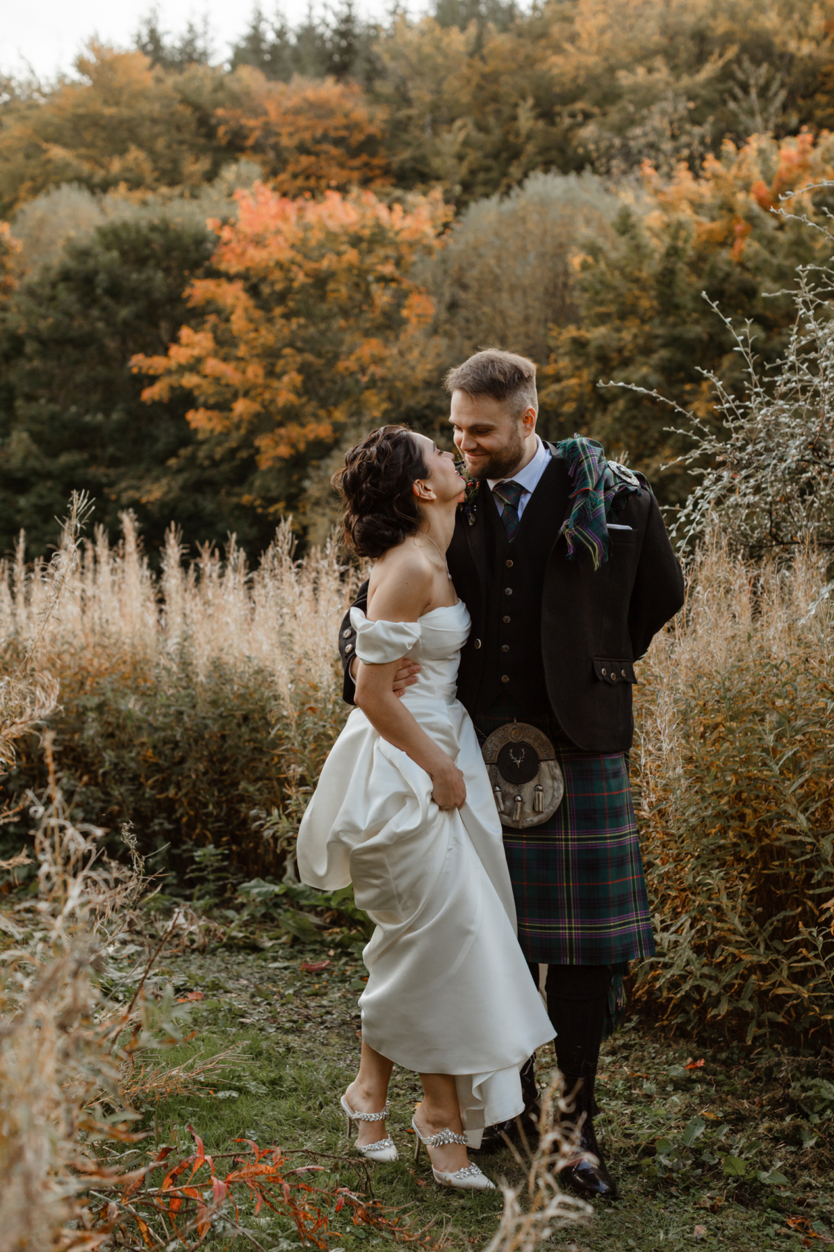 Savannah Miller Elegance for a Joyful Autumn Wedding at Drumtochty Castle 17 Bride wearing Danielle by Savannah Miller and Manolo Blahnik pearl mules as she gazes lovingly into her groom's eyes. He wears a kilt in Kennedy tartan.