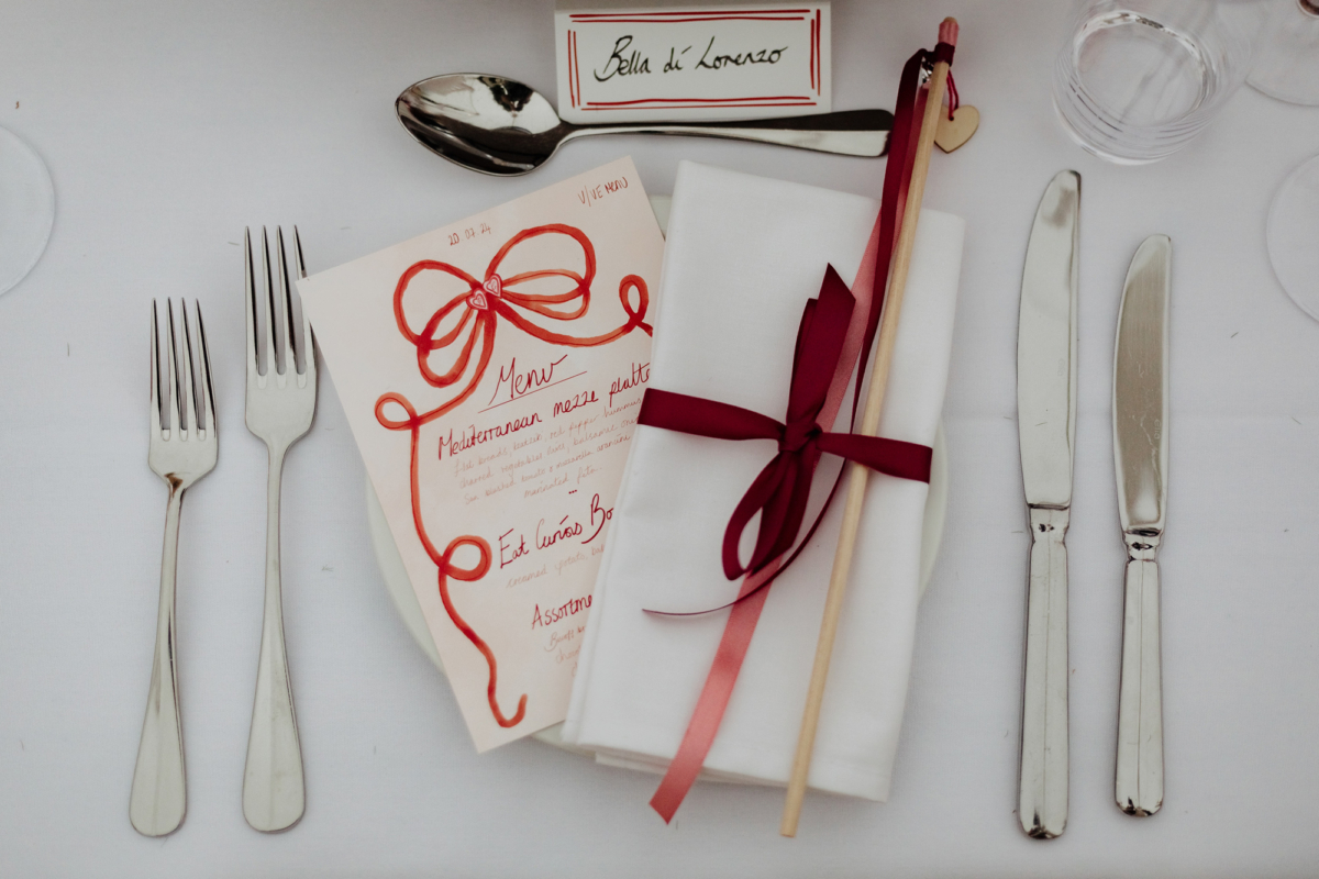 Wedding stationery with red ribbon illustration. Velvet red ribbon used to tie the guests waving sticks.