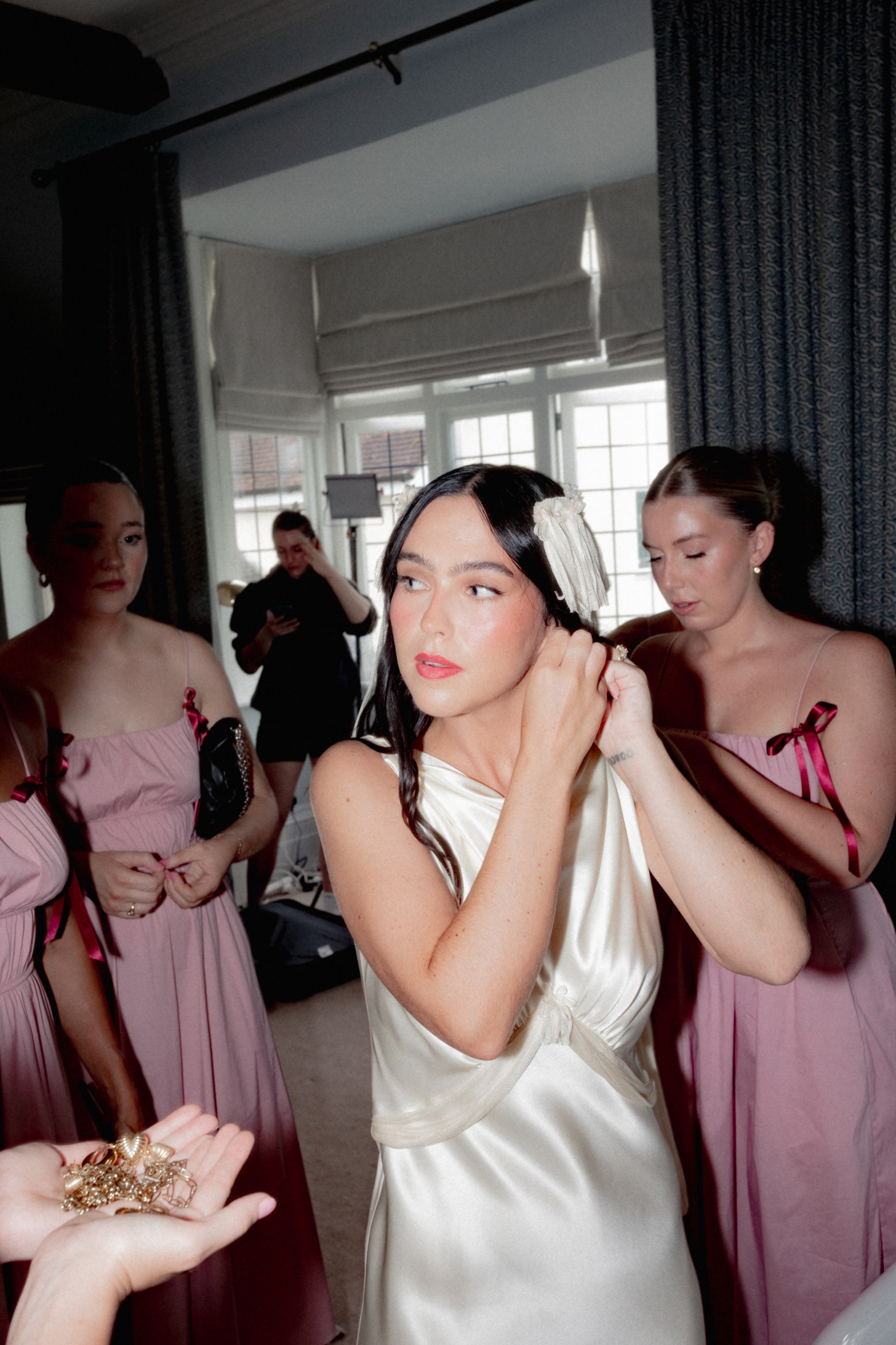 Bride putting on her fringed and tasseled Paula Nanda veil and wedding dress.