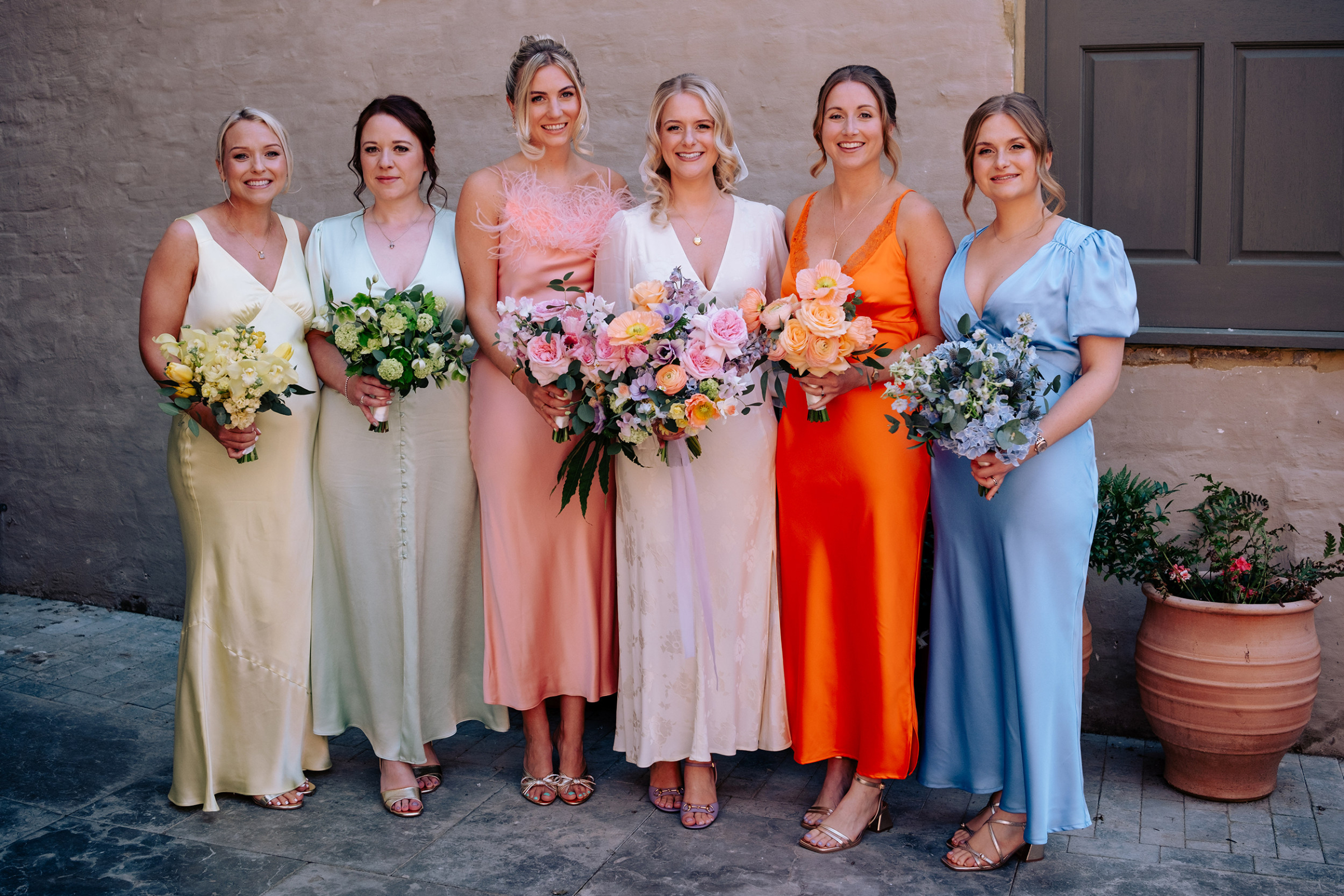 Bridesmaids in colourful dresses.