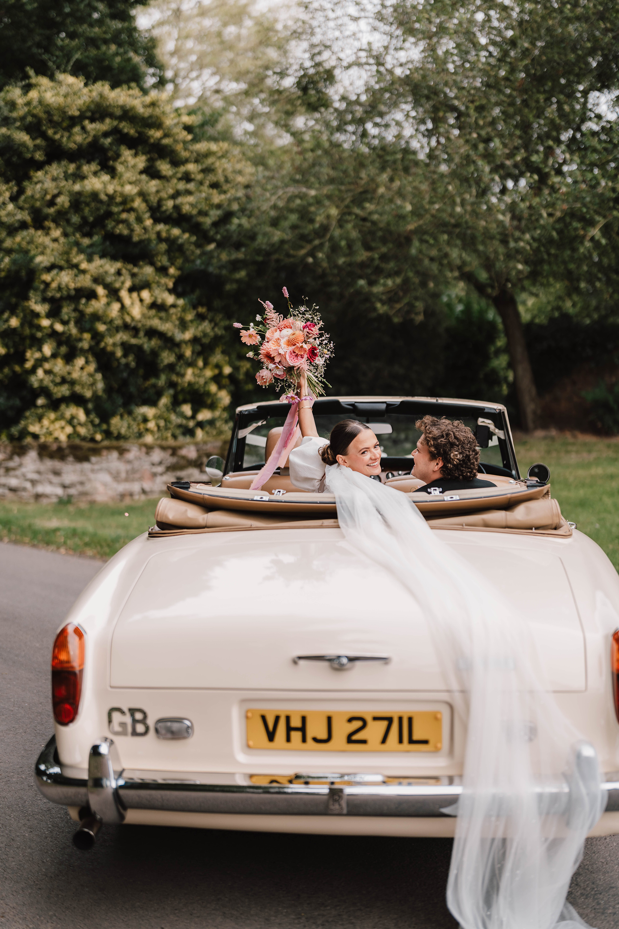 Bride and groom in wedding car