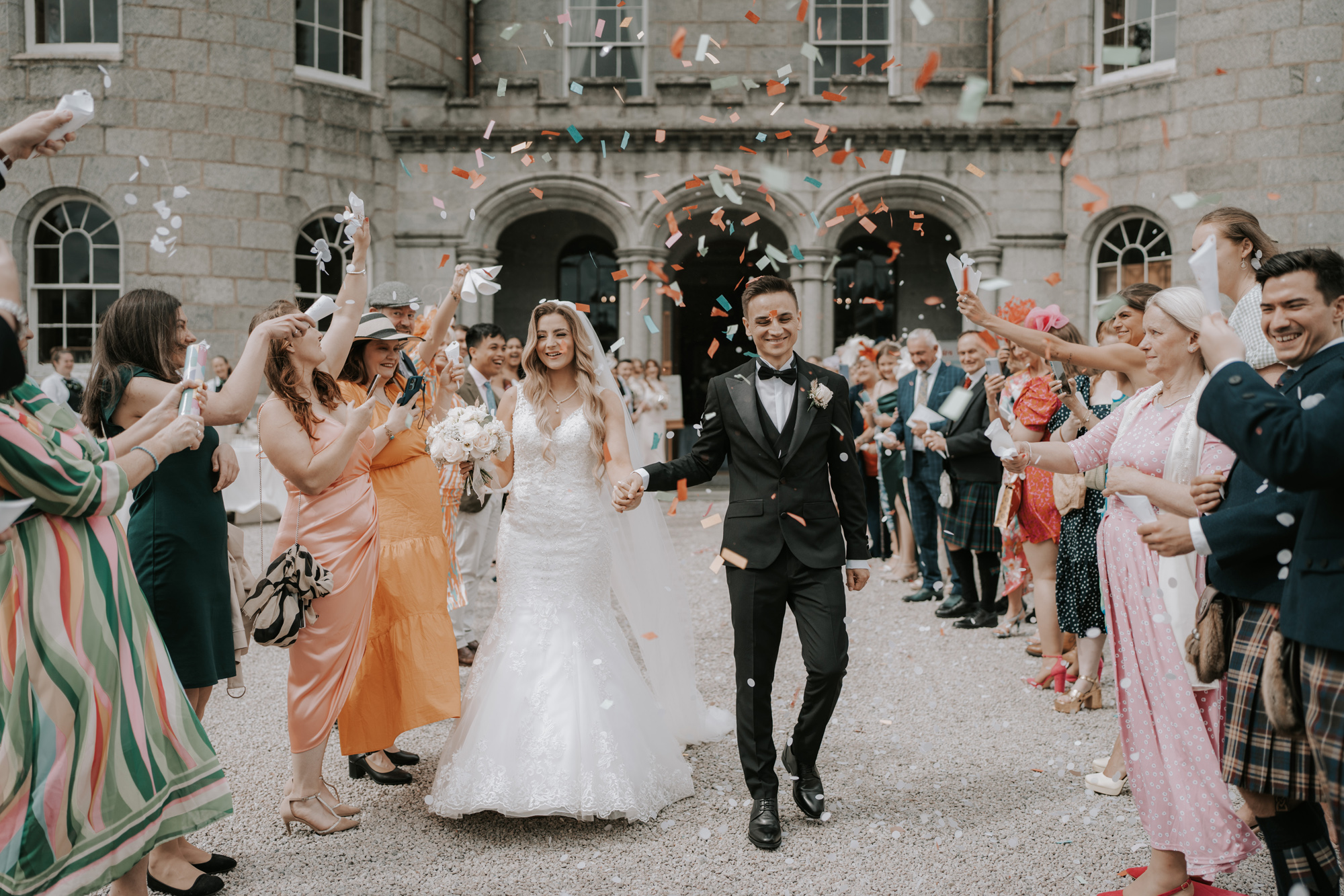 Cluny Castle Aberdeenshire Wedding Venue 59 - A Romantic Multicultural Wedding at Cluny Castle in Aberdeenshire Bride and groom being showered in confetti at Cluny Castle Aberdeenshire Wedding Venue