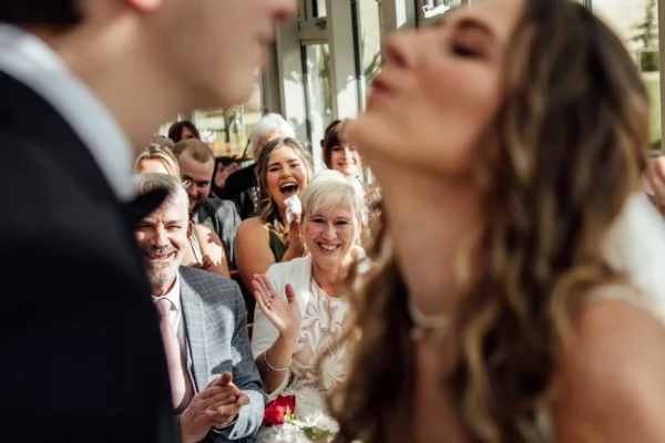 A bride and groom kiss during their wedding.