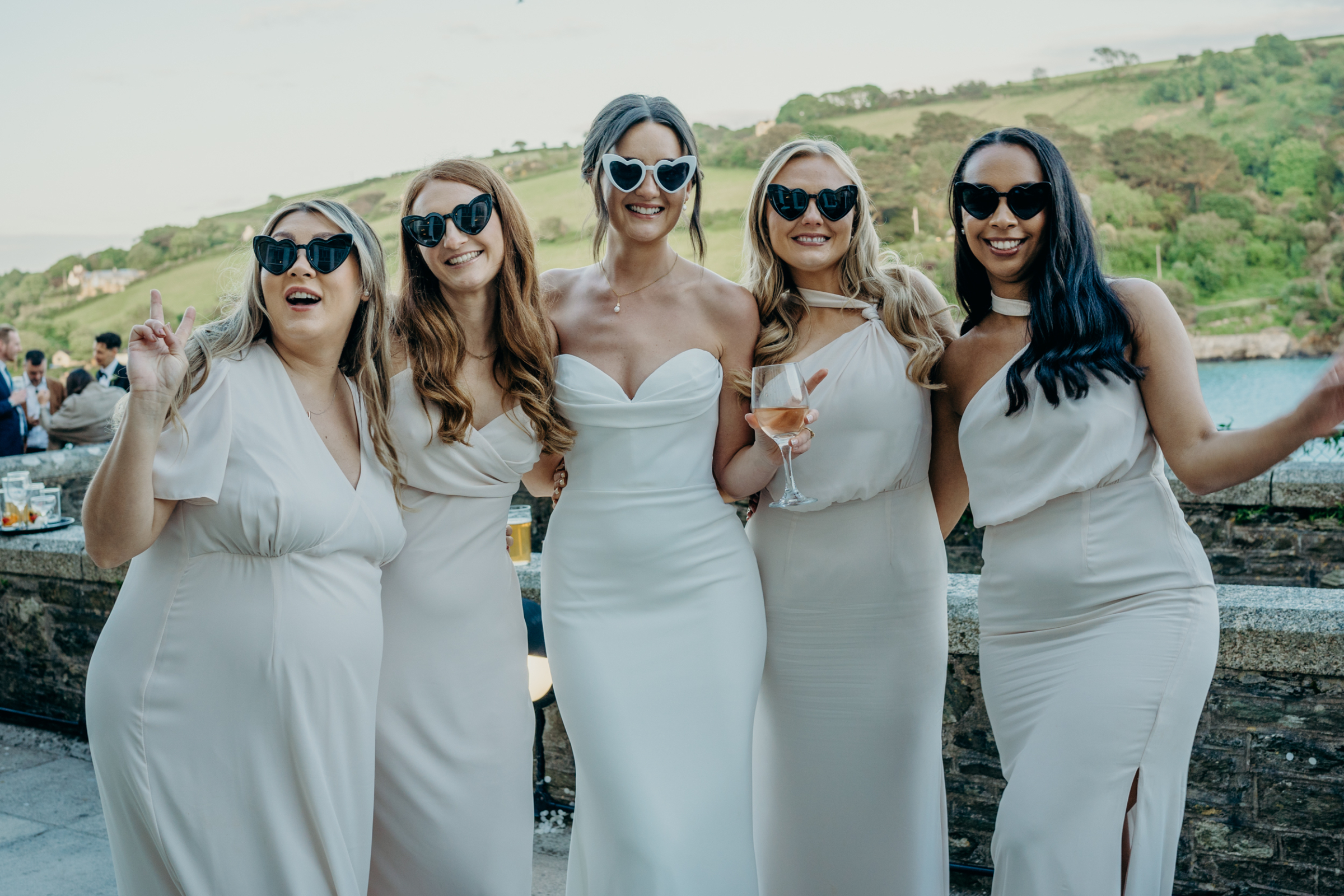 Bride and her bridesmaids wearing heart shaped sunglasses. Salcombe Devon Wedding.