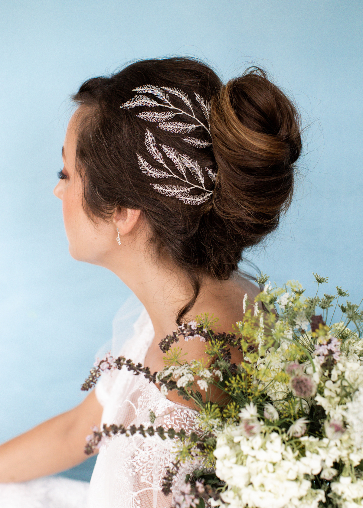 Model bride wearing a delicate and handmade silver leaf bridal headpiece by Judith Brown Bridal.