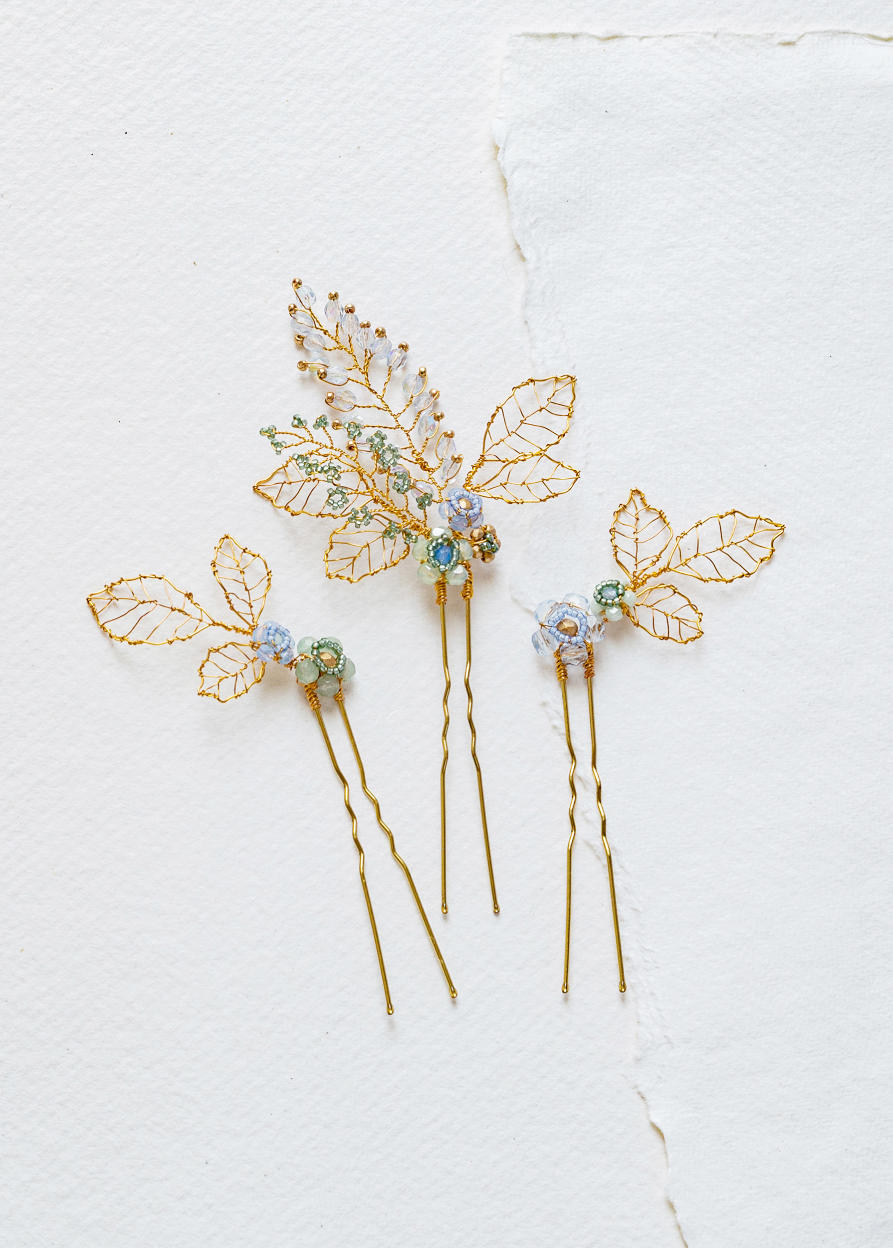 Delicate gold leaf and blue flower hair pins by Judith Brown Bridal.