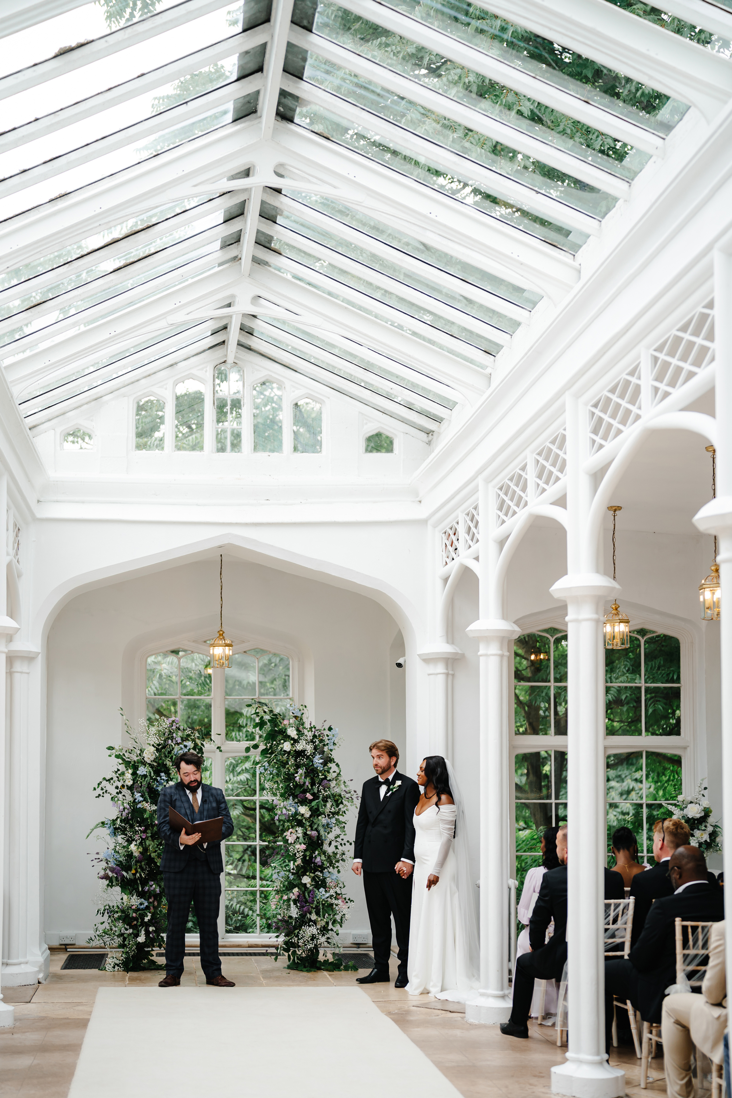 Black bride and her groom during their wedding ceremony at St Audries Park in Somerset. She wears Bronte by Sarah Seven. Jodie Hurd Photography.