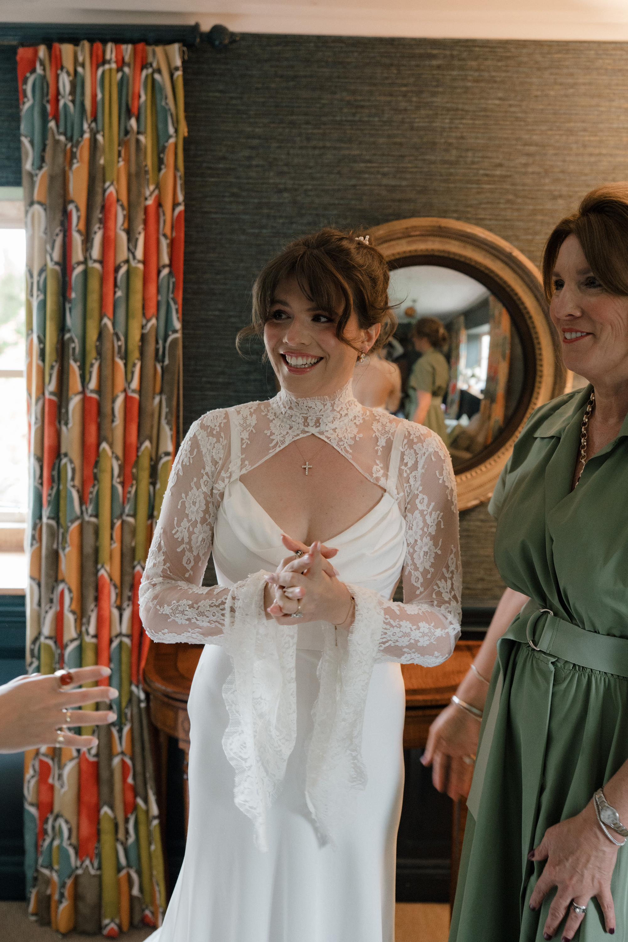 Bride getting ready in her Saint Bridal Couture dress at Gulliver's Hall, a Unique Home Stays wedding venue in The Cotswolds.