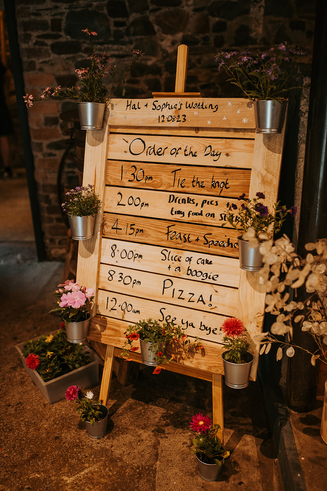 Wedding order of day created on a wooden sign made of pallette wood. Low Hall The Lakes rustic English country wedding venue in The Lake District.