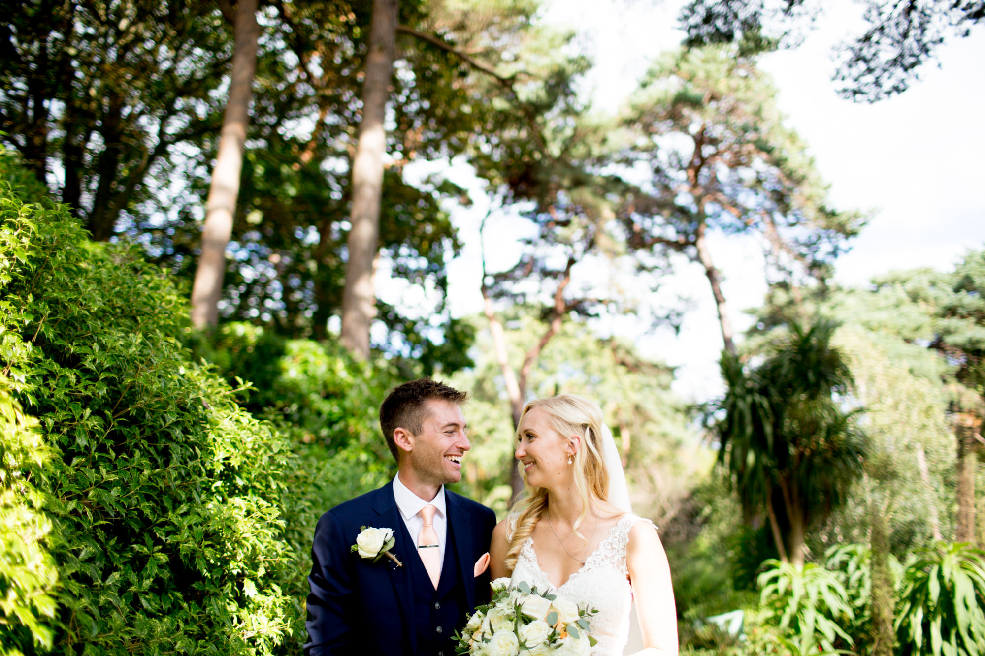 Gentle and romantic wedding photography of bride and groom looking lovingly at one another and smiling/laughing. by Jessica Hayman, Hampshire wedding photographer.