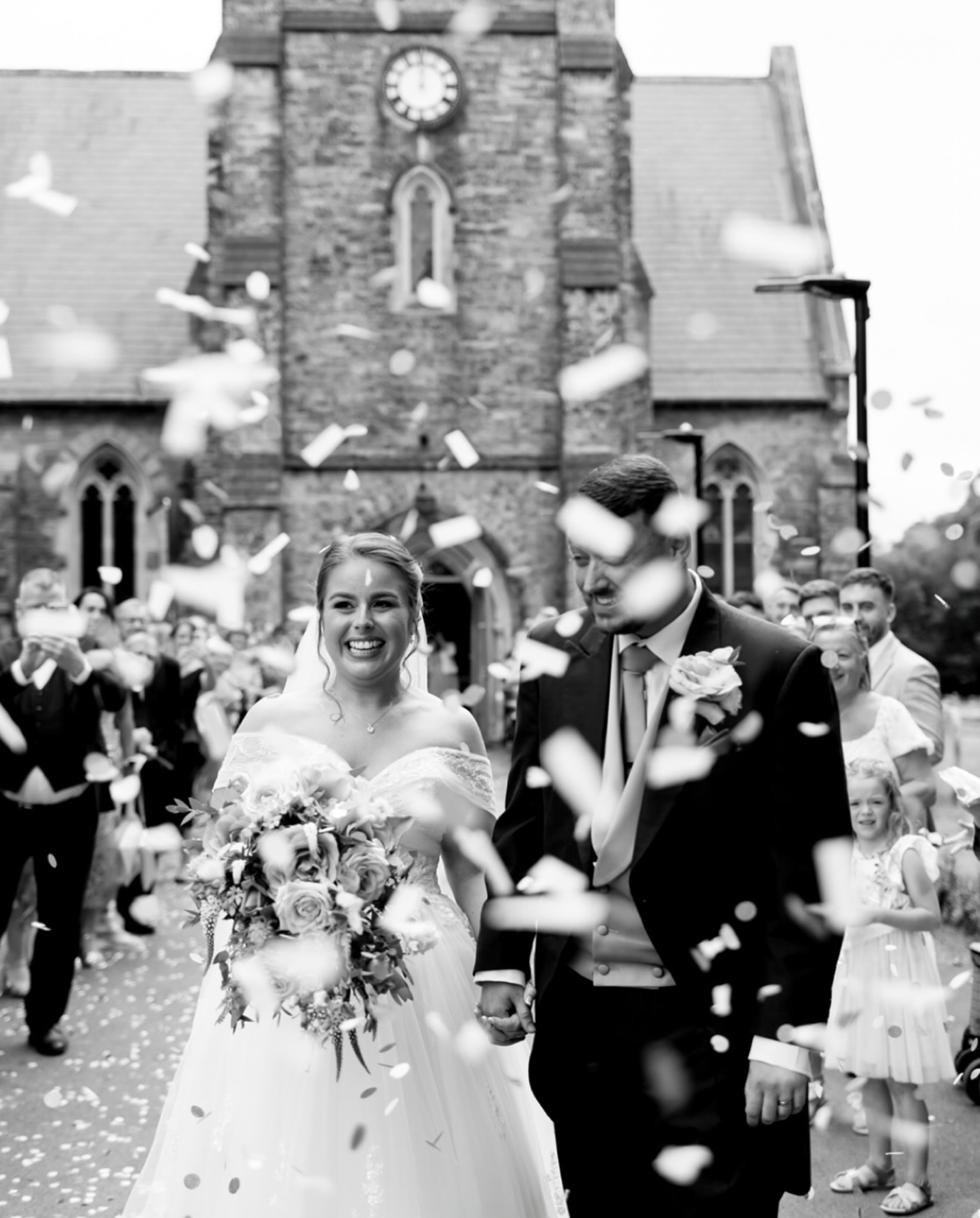 Introducing Jessica Hayman, Hampshire Wedding Photographer 23 Joy filled image of bride and groom being showed in confetti outside the church in a just married joy moment! Image by Hampshire wedding photographer, Jessica Hayman.