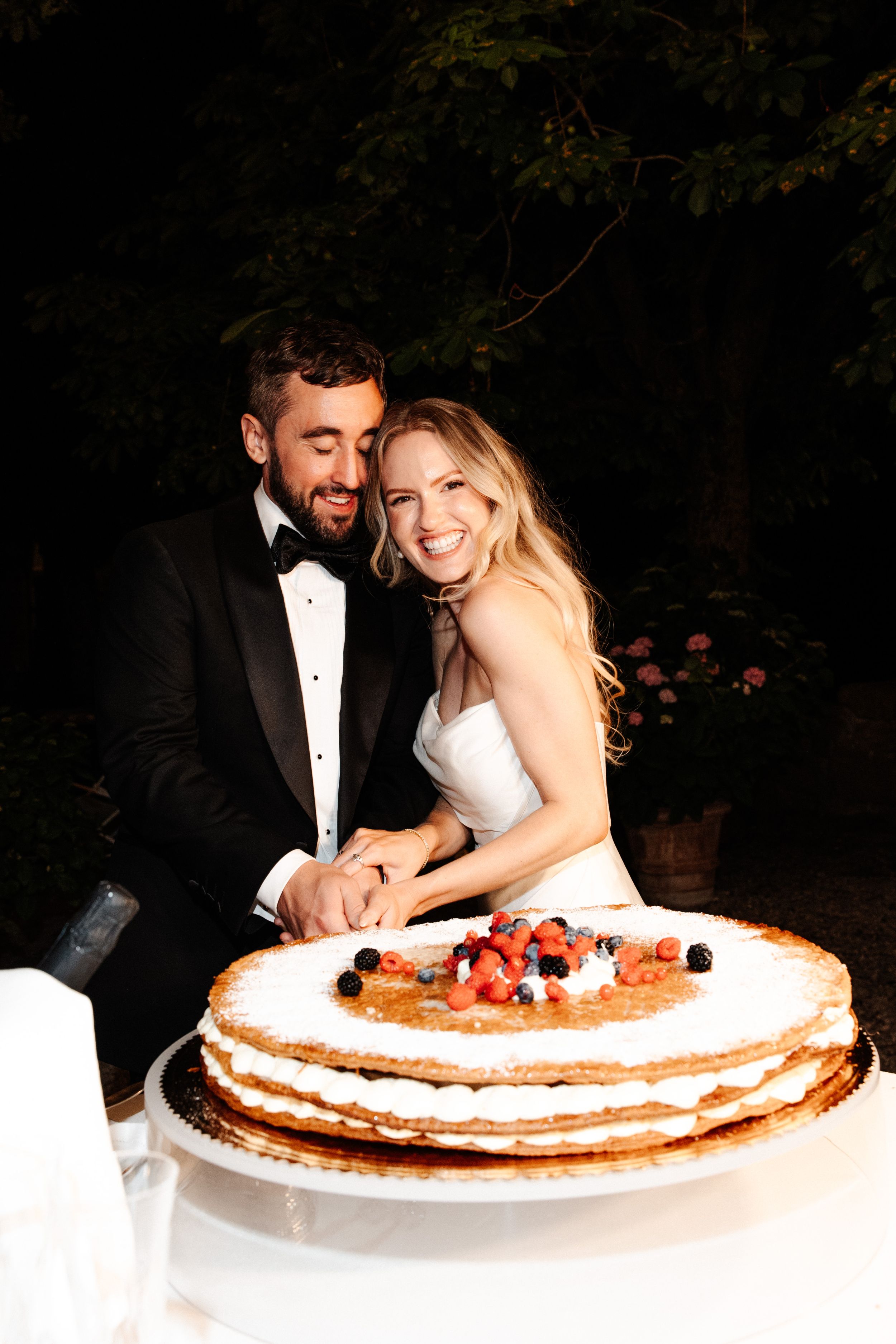 Wedding Borgo Sant Ambrogio Tuscany Italy 160 - A Modern, Romantic Destination Wedding at Borgo Sant Ambrogio in Tuscany Bride and groom gleefully cutting into their millefoglie wedding cake.