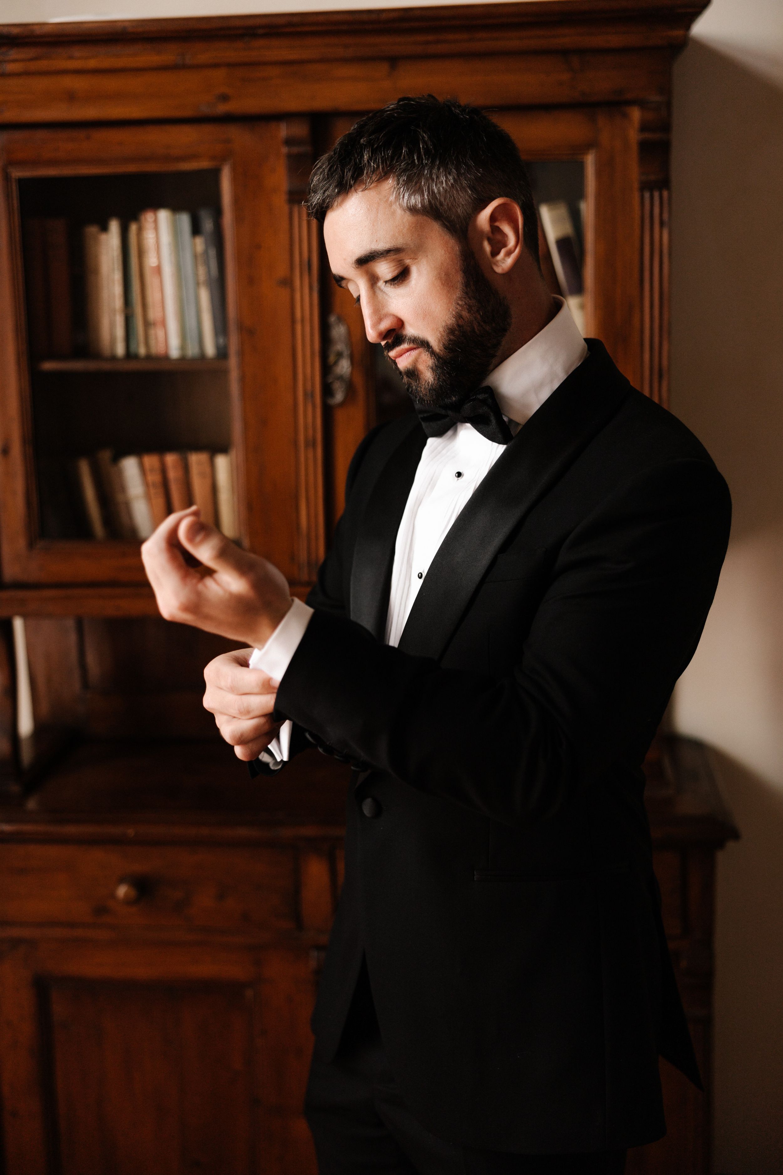 rachelluke 118 - A Modern, Romantic Destination Wedding at Borgo Sant Ambrogio in Tuscany Elegant modern groom wearing black tie and putting his cufflinks on.