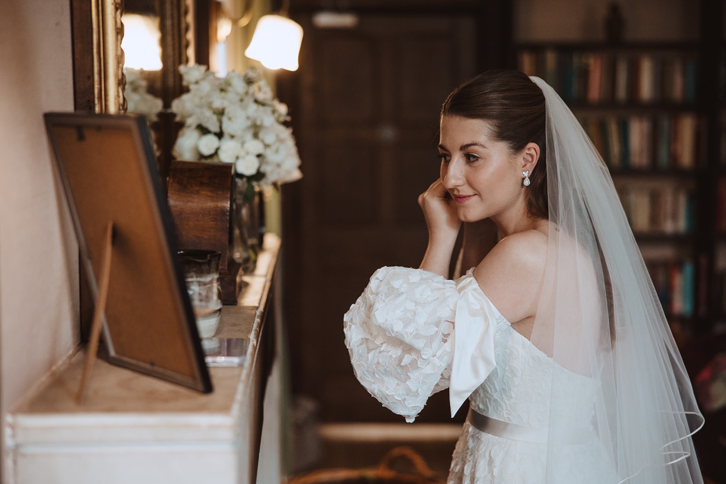 Bore Place Wedding Sassi Holford bride 24 - Hatty & Ben’s Nancy Meyers Inspired Black Tie Wedding at Bore Place, Kent Bride wearing a Sassi Holford gown and checking her makeup in the mirror.