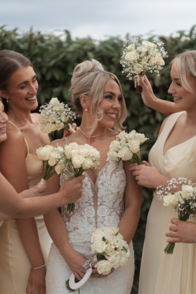 Bride and her bridesmaids in a close up with flowers