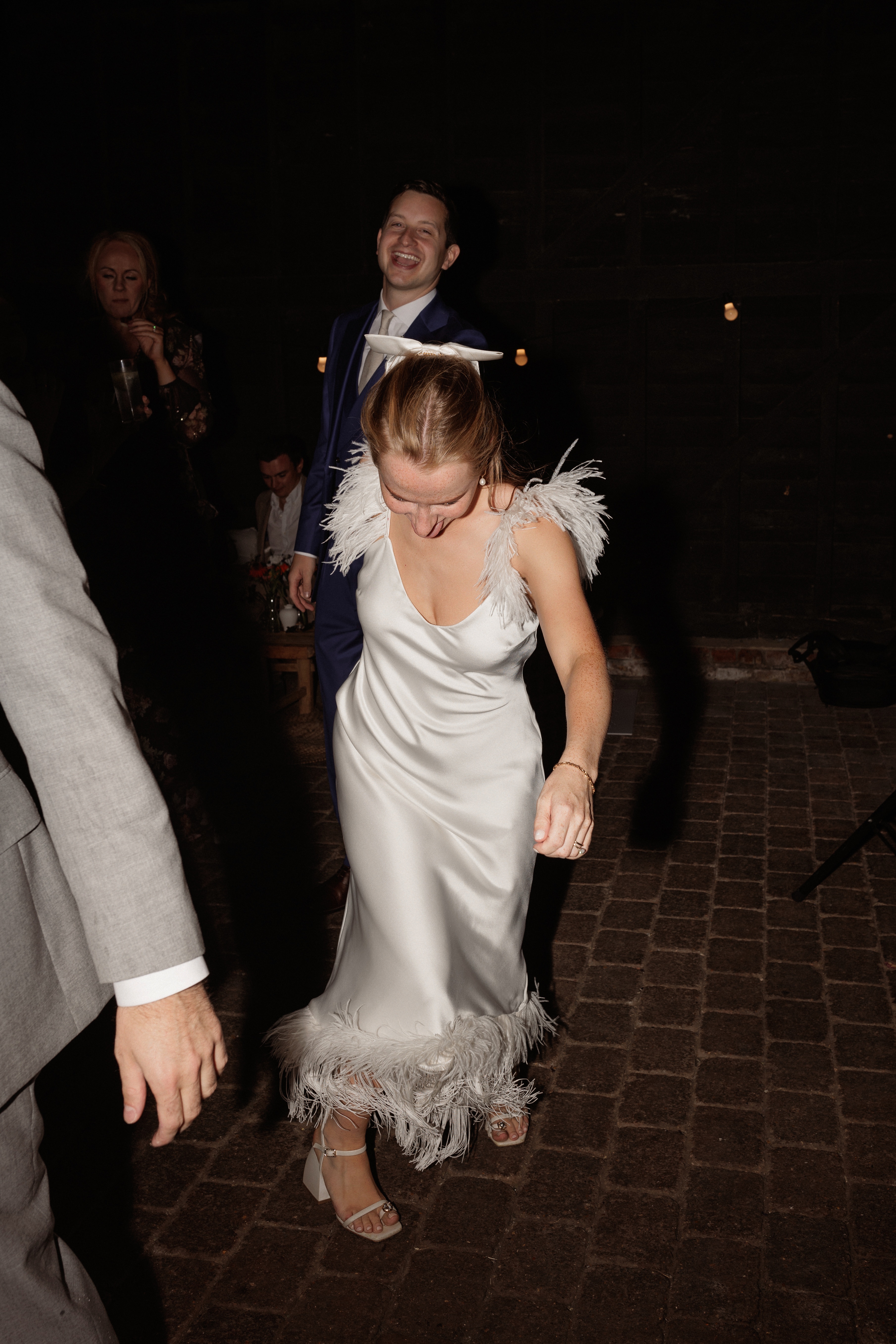 A Summer Wedding at Elmley Nature Reserve with Halfpenny London 108 Bride wearing chunky heels, a Halfpenny London dress with ostrich feather shoulders. Elmley Nature Reserve wedding, Kent.