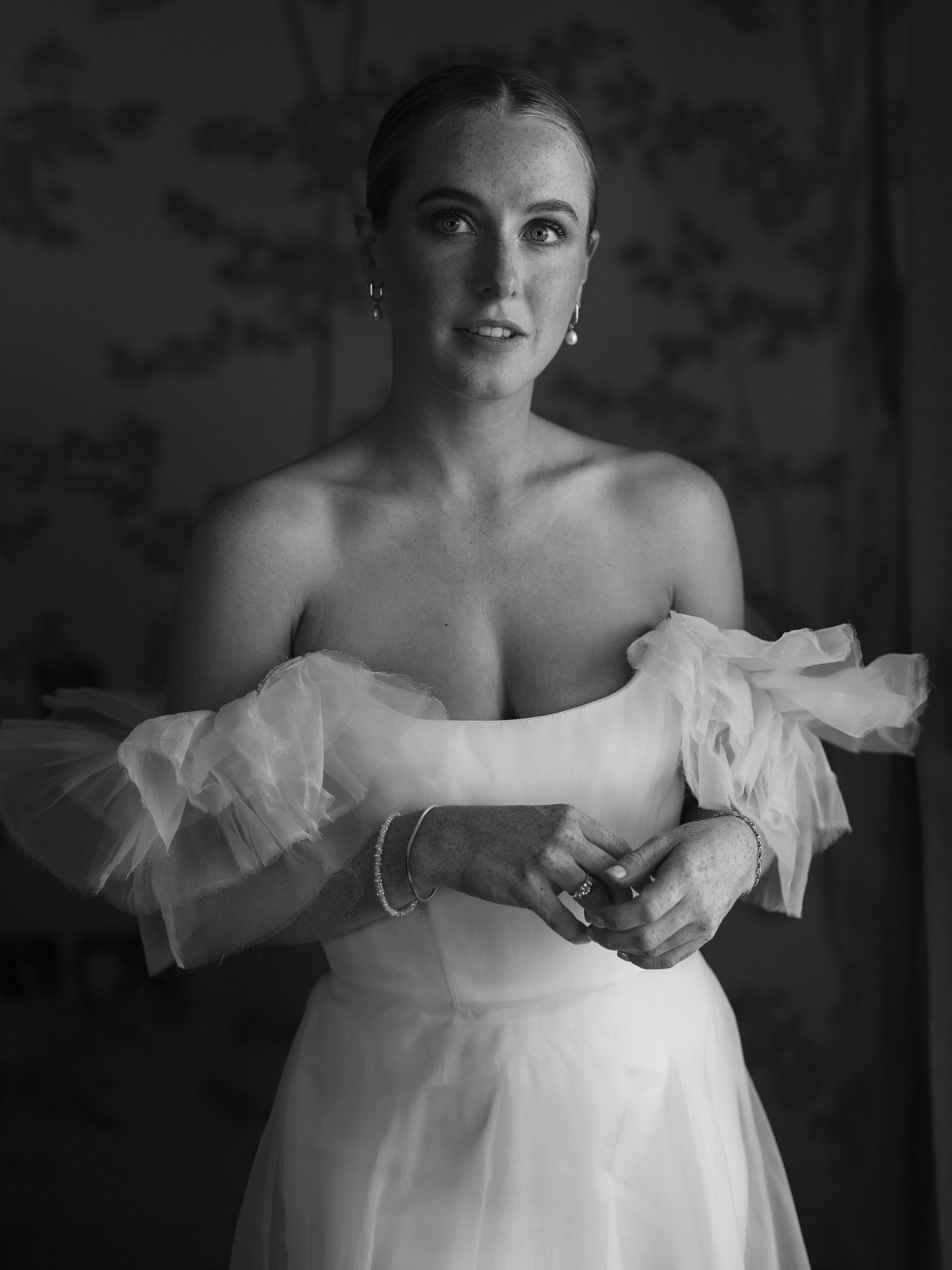 A Summer Wedding at Elmley Nature Reserve with Halfpenny London 50 Intimate blac and white portrait of bride in a Halfpenny London dress with frilly sleeves.