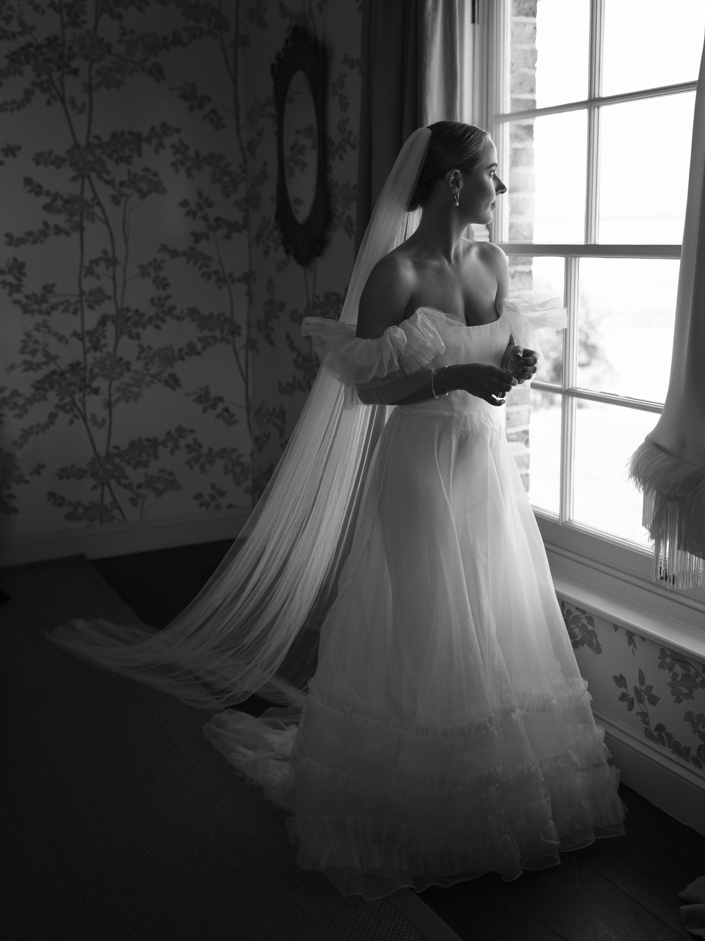 A Summer Wedding at Elmley Nature Reserve with Halfpenny London 45 Bride in a Halfpenny London dress with frilly sleeves and a long single tier veil.