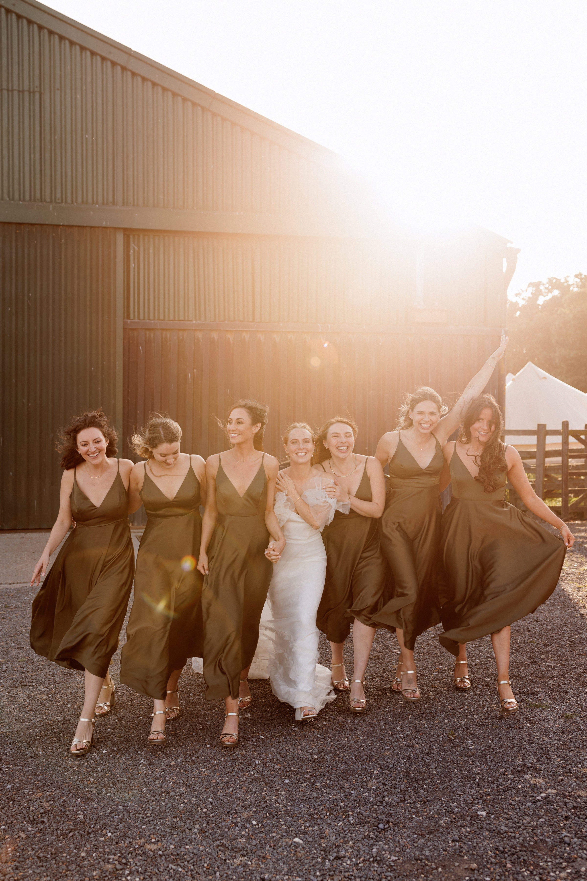 A Summer Wedding at Elmley Nature Reserve with Halfpenny London 99 Bride and her bridesmaids. olive green ASOS dresses at golden hour at Elmley Nature Reserve wedding venue in Kent.