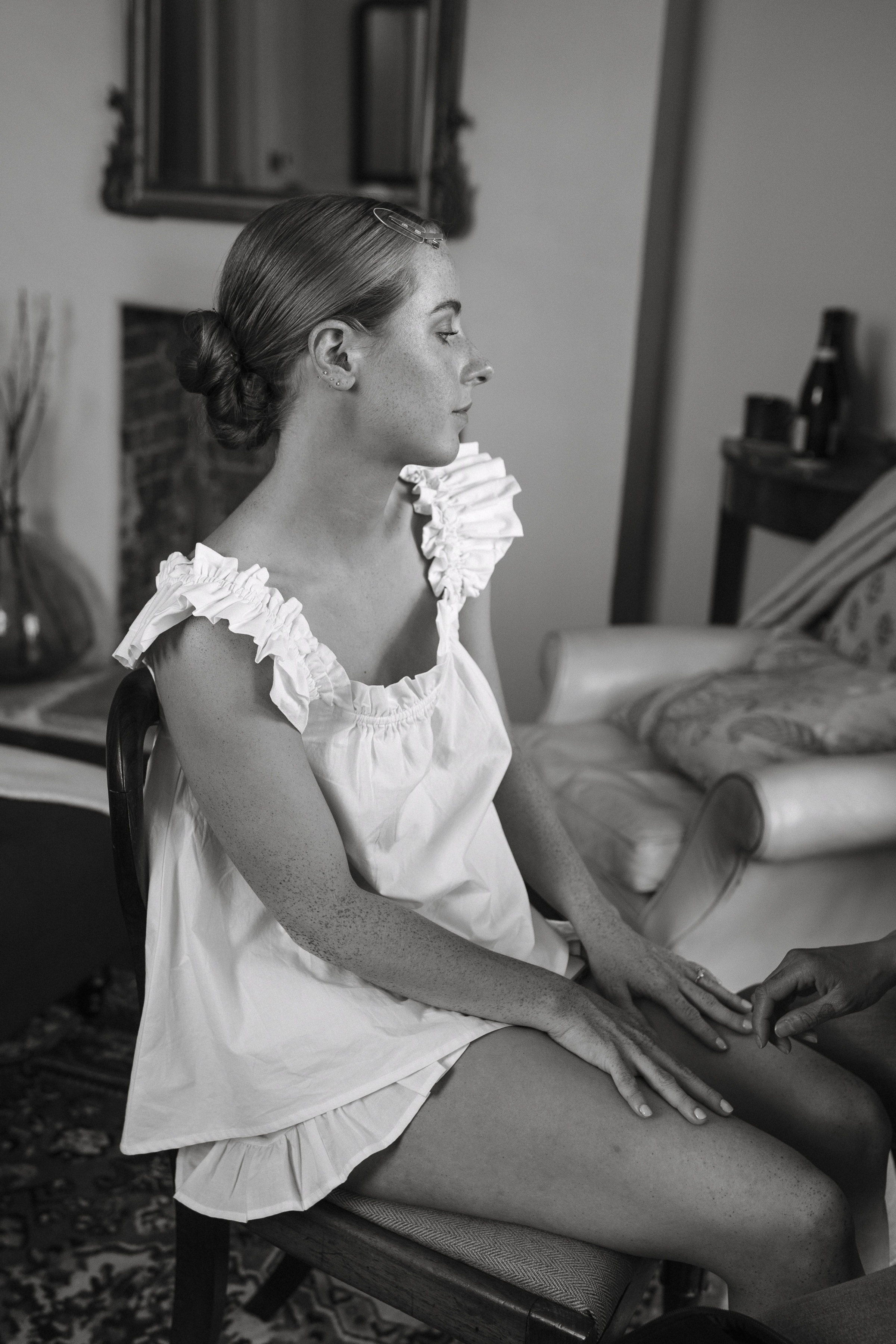 A Summer Wedding at Elmley Nature Reserve with Halfpenny London 42 Bride in frilly cotton pyjamas getting ready on. wedding day.her